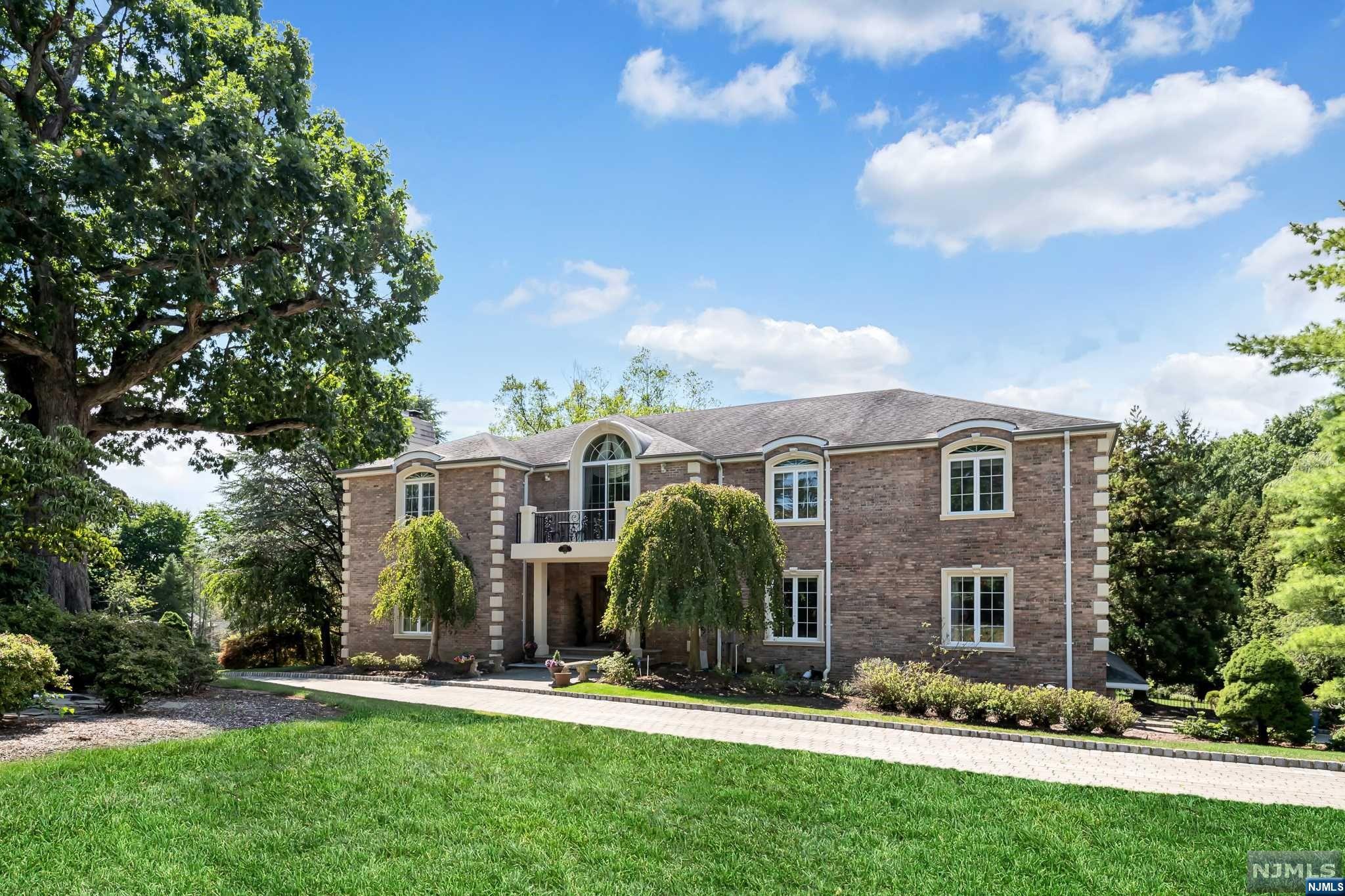 Majestic 5 bedroom Manor on beautiful acre property offers a peaceful, elegant retreat with extensive custom millwork & details. Grand 2 story foyer with marble flooring welcomes you & leads to the formal living room with gas fireplace & accent lighting. French doors open to the sun filled private library with walls of windows & coffered ceilings. Formal dining room & butler's pantry opens to huge updated (2012) kitchen, large island & breakfast rm with fireplace. Doors open to large private deck. Spectacular 2 story great room with fireplace, bar with martini shaped custom sink, floor to ceiling windows & open to an inviting sunroom with walls of windows. 1st floor bedroom suite with full bath. 2nd floor balcony leads to primary bedroom with tray ceiling, luxurious bath, & huge walk-in closet. 3 spacious bedrooms plus 2 more updated full baths. Walkout lower level features billiard/family rm with fireplace, home theater, gym, guest space, full bath. Windows 2012, 3 car garage.