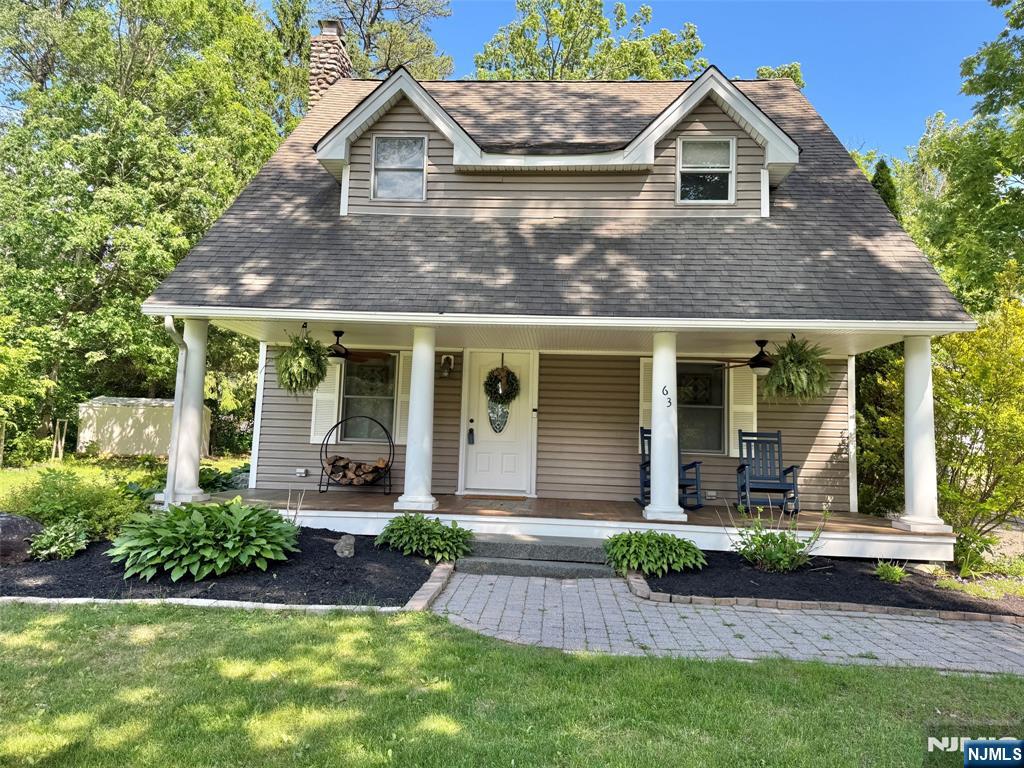 Located in the desirable Awosting community of Greenwood Lake, this beautifully maintained 4-bedroom, 2.5-bath Colonial offers the perfect blend of charm, comfort, and lake living. A spacious covered front porch with mahogany wood flooring and ceiling fans welcomes you home and sets the tone for the relaxed lifestyle this property offers. Inside, the sun-filled layout features a cozy family room with a wood-burning stove, a bright living room with a wood-burning fireplace, and a charming kitchen with breakfast nook flowing into a generously sized dining room, ideal for everyday living and entertaining. The main level also includes a laundry room and stylish powder room with barn doors. Upstairs you'll find four spacious bedrooms, including a primary suite with private bath and walk-in closet, plus an updated full hall bath. Outside, enjoy a paver patio, private backyard, detached 1-car garage, generator hook-up, and public water/sewer. Inside includes a central vacuum unit, central air and a brand new high efficiency furnace. Enjoy all that this private lake community has to offer: a private beach, two private boat launches, kayaking, fishing, swimming, tennis courts, basketball courts, playground, clubhouse, and year-round community events. This is not just a home, it's your new lifestyle.