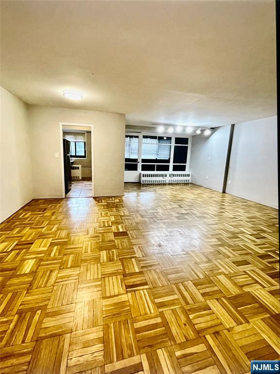 This functional open and very spacious layout unit with sun room offers comfort, warmth and convenient living style that is close to hospital and easy commute to NYC. This second floor unit has been well maintained with hardwood floor and new appliances. ALL UTILITIES ARE INCLUDED: HEAT, WATER, ELECTRICITY, AND MAINTENANCE. Also, one parking space (#17) is included with the unit. The building offers a full suite of amenities, including 24-hour security (doorman), concierge service for package handling, a newly renovated laundry facility, and additional storage options. ***TENANT IS RESPONSIBLE FOR 1 MONTH REALTOR FEE and 1.5 MONTH DEPOSIT. MUST COMPLETE APPLICATION.*** *** Small Pets under 15lbs are okay with agreement and additional pet deposit.***