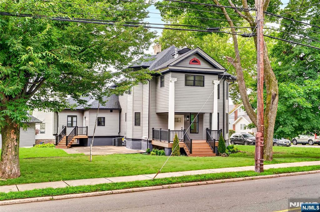 Beautifully renovated Victorian home offering the charm of a classic design with the quality of modern construction. Completely rebuilt from the studs in a professionally designed and permitted renovation, this move-in ready home offers over 3,000 sq. ft. of above-grade living space plus a finished walkout basement. Situated on a spacious corner lot in one of Teaneck's most desirable neighborhoods, the home was thoughtfully designed for modern living, entertaining, and multigenerational flexibility. The unique dual kitchen design features multiple cooktops, ovens, dishwashers, sinks, and separate refrigeration, making meal preparation and entertaining effortless. Bright, open living spaces flow throughout the main level. The second floor features a spacious primary suite, two additional bedrooms, and a full bath, while the third floor offers a private suite with its own full bath. The finished walkout basement includes a half bath and direct backyard access, providing exceptional space for recreation, a home office, gym, or guest accommodations. Major improvements include a new roof, siding, windows, doors, HVAC, electrical, plumbing, flooring, insulation, drywall, lighting, landscaping, and an updated detached garage. Conveniently located near parks, schools, shopping, transportation, and houses of worship. A rare opportunity to own a move-in ready home with the quality and feel of new construction.