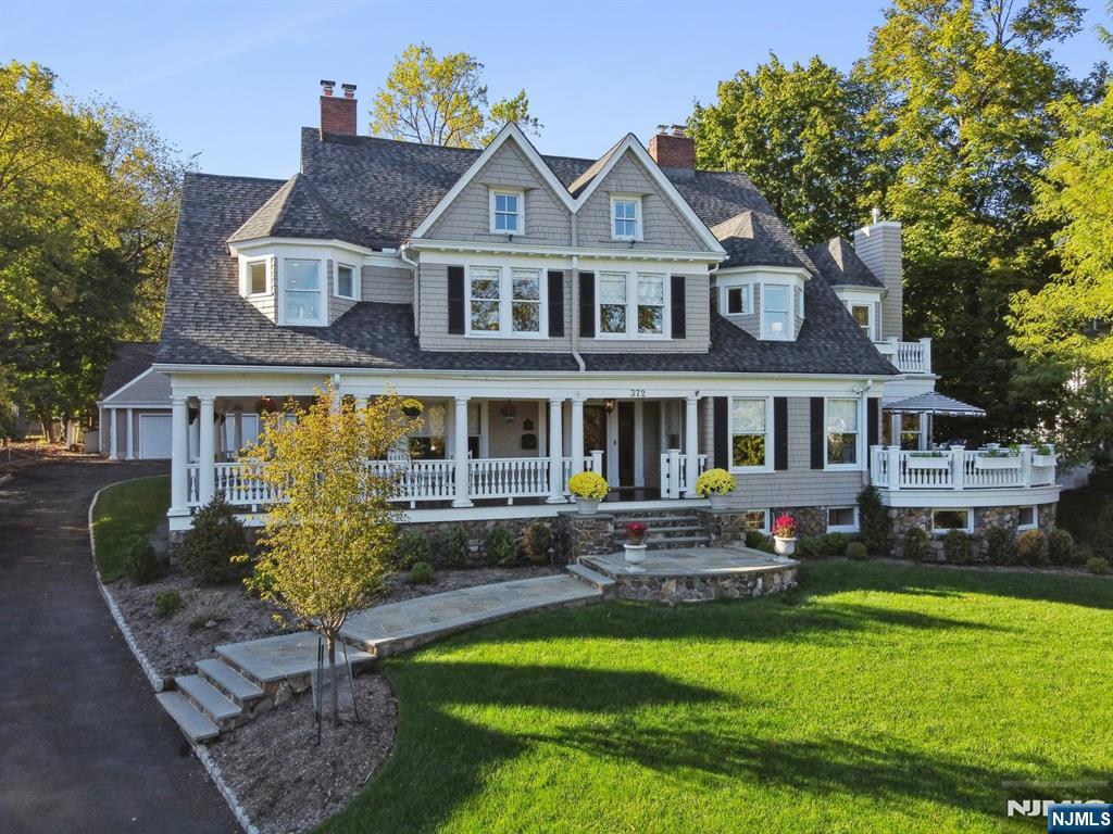 Move right into this warm, inviting home ideal for indoor and outdoor entertaining that blends everyday luxury with unparalleled convenience in the heart of Upper Montclair. Just 2 blocks to the NYC train, top dining, shops, and the Bellevue Theatre, this home offers city-like accessibility with neighborhood charm. Inside, the chef's kitchen is a true showpiece with a Wolf range, SubZero fridge, warming drawers, dual dishwashers, two sinks and a natural gas fireplace. A large center island and access to the gas-connected grill deck make this space perfect for both daily living and entertaining. The 1st floor also features a living room with exquisite millwork and a gas fireplace, a formal dining room with gas fireplace and seating for 12, a rotunda-style family room, and a powder room and mudroom for everyday ease. Upstairs, the luxurious primary suite awaits with an attached private office, marble bath and large walk-in closet. Four bedrooms - two with en suite baths - a hall bath, and luxe laundry rm complete the 2nd floor. The 3rd floor includes two more bedrooms, a full bath, and a bonus room. Versatile basement includes wine room, gym, hobby room, family room, a custom sensory gym (with home theater potential), and powder room. Enjoy outdoor living without upkeep: a mahogany wrap-around porch is perfect for entertaining or relaxing and the deck off the kitchen makes al fresco dining easy. Roast s'mores on the bluestone patio or play pickleball on the oversized driveway.