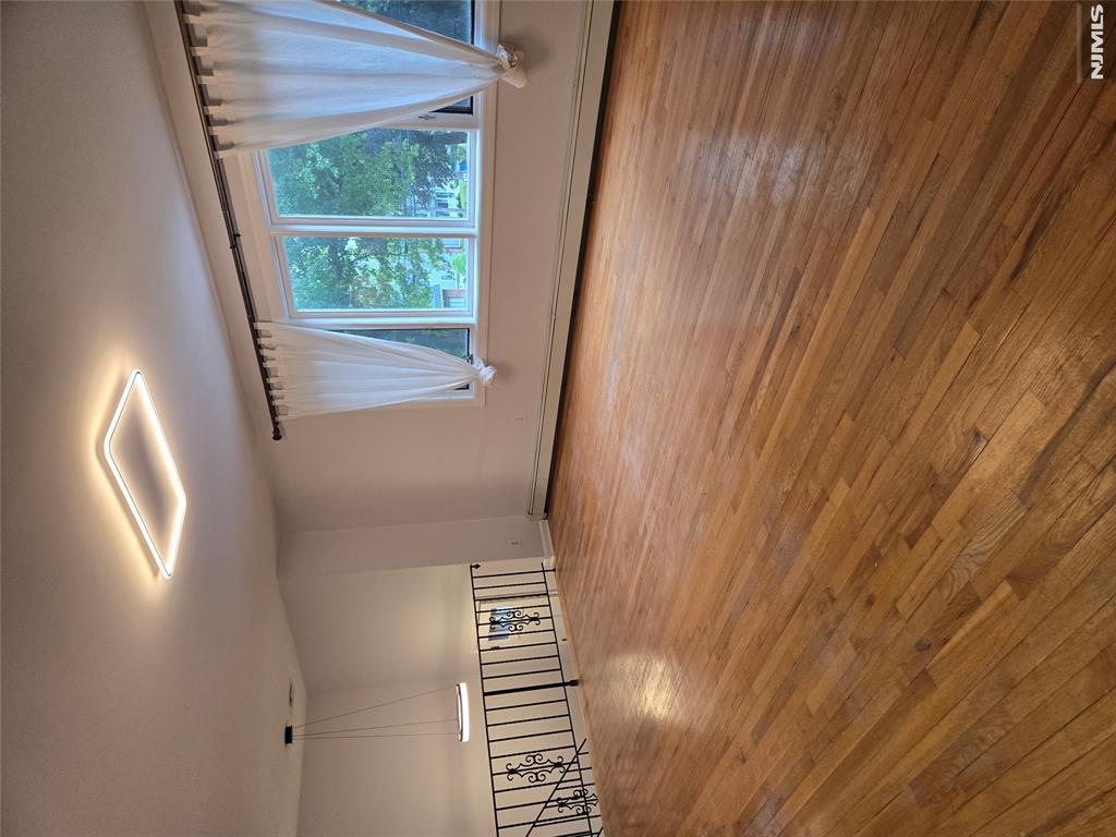 Completely renovated 3 full bathrooms, New Boiler and hot water tank. Bright and Spacious South-Facing Home with Exceptional Multi-Generational Living Potential. Welcome to this sun-filled south-facing residence featuring beautiful hardwood floors throughout and baseboard heating and air conditioning for year-round comfort. The ground level offers a separate entrance, a cozy fireplace, a summer kitchen, a bedroom/home office, and direct access to a private patioâ€”making it ideal for extended family living, guests, or a flexible work-from-home setup. Enjoy outdoor living in the huge fenced backyard, perfect for entertaining, recreation, or gardening. Parking is never an issue with a 2-car garage plus an oversized driveway accommodating up to 4 additional vehicles. Conveniently located near shopping, parks, and public transportation, this well-maintained home combines comfort, space, and versatility in a highly desirable location. A rare opportunity for extended families or anyone seeking extra living space and convenience.