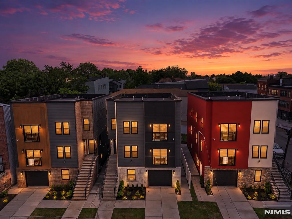 The multifamily game has changed, and these homes are proof of it. Designed with intention and built to stand apart, this is anything but your typical new construction. Every detail has been carefully curated, from the striking facade contrasts and unique architectural designs to the thoughtfully planned landscaping, all tailored to complement today's lifestyle. We are fortunate to offer only three of these exceptional residences. The wait is over. Welcome to these beautifully sized homes featuring a ground level designed for both functionality and entertaining, complete with an open flex space, a half bathroom, elegant tile work throughout, a two car tandem garage, and sliding doors leading to your private paved patio and grassy backyard. Each home offers two spacious apartments, with every unit featuring three bedrooms and two full bathrooms, including a primary suite. Unique accent walls, designer finishes, Juliet balconies, oversized living areas, and stunning kitchens with abundant cabinetry and peninsula seating complete the experience. Offering a total of six bedrooms and five and a half bathrooms, these homes are conveniently located near major highways, airports, public transportation, shopping, and more. You need to see them in person to truly appreciate everything they have to offer. *** 5 YEARS TAX ABATEMENT ***