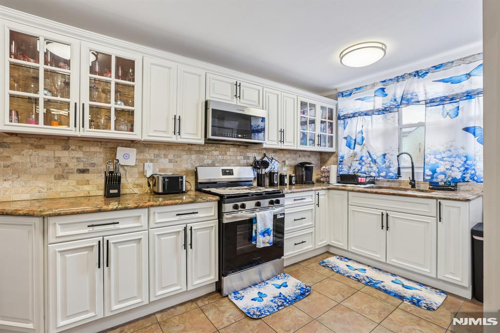 Move-In Ready-Just Unpack and Enjoy! Beautifully maintained One-Family home with plenty of natural light and hardwood floors throughout, featuring 3 spacious bedrooms and 2 full bathrooms. Step into a welcoming foyer that leads to an open and inviting layout with a large living room, dining and recently renovated kitchen with granite countertops, stainless steel appliances.The second floor boasts three generously sized bedrooms with ample closet space and walk up attic for additional space and storage. Full finished walk-out basement perfect for extra living space or extended family, a large family/Recreation room or home office and full bath. Additionally this home offers hi tech features, 2yr old roof, central air, a garage, driveway, back porch and gorgeous yard ideal for entertaining! Conveniently located near shopping, dining, parks, and NYC transportation. Pictures Coming Soon