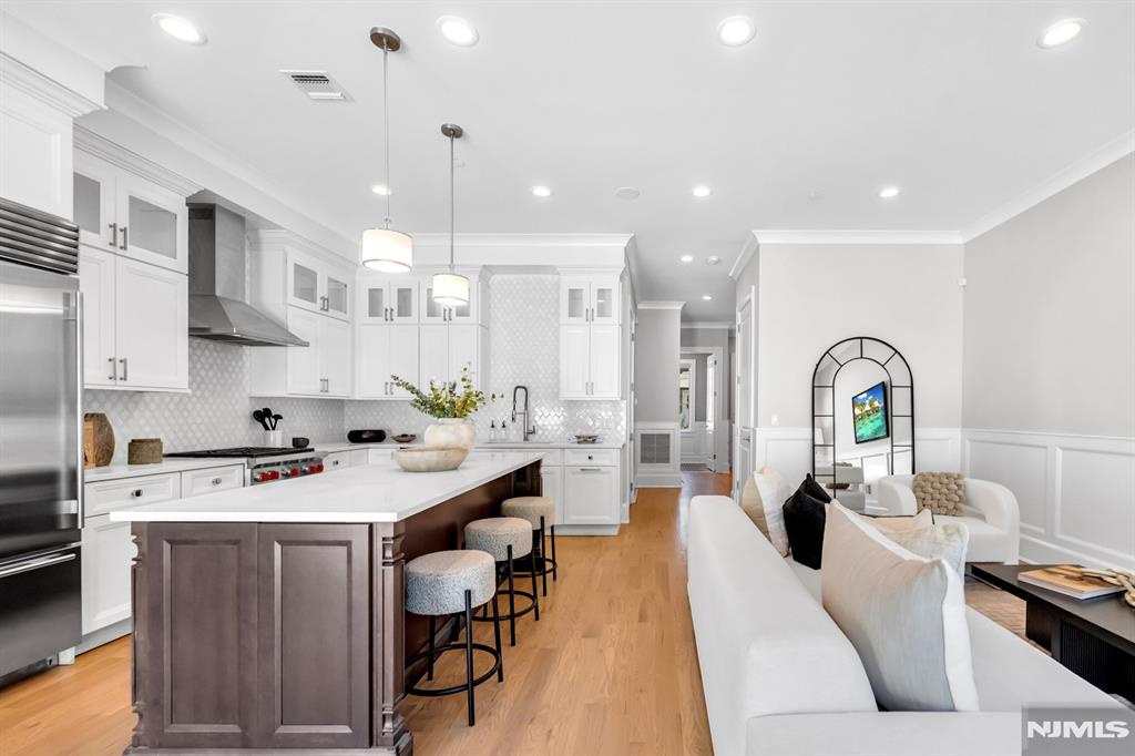 Stunning luxury townhome in Gabriel Estates, a boutique community in the heart of Paramus. Built just a few years ago, this residence has 3 bedrooms, 2 full baths, and 2 half baths, the home offers soaring 10-ft ceilings on the main level and 9-ft ceilings upstairs, creating a bright, airy ambiance. The gourmet kitchen showcases Sub-Zero and Wolf appliances, quartz countertops, and sliding glass doors that open to a private, fenced backyard. The impressive primary suite includes a massive walk-in closet and a spa-like bath with a Jacuzzi tub, oversized shower, and a double vanity. A fully finished lower level extends the living space with a spacious recreation room and a custom wet bar perfect for entertaining. Outdoor living is complete with a private patio and yard, all just minutes from the Garden State Parkway, Route 17, world-class shopping, and Paramusâ€™ top-rated schools.