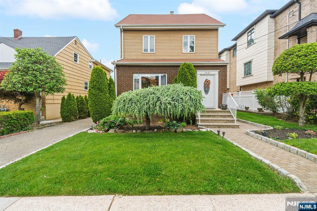 Welcome to this beautifully maintained home on desirable Maple Street in Fort Lee. The inviting first floor features an entry foyer that opens to a spacious formal living room and a large formal dining room, perfect for entertaining. The modern eat-in kitchen offers great everyday functionality, while the family room addition provides a warm and inviting space complete with a wood-burning fireplace and sliding doors leading to a private backyard patio. The second floor offers three bedrooms, including a primary suite with a full bath and convenient laundry access. Two additional bedrooms and a full hall bath complete the upper level. Additional amenities include a walk-up attic with air conditioning, offering flexible space for storage, recreation, or play. The home also features an unfinished basement and a detached garage for added convenience. Ideally located close to NYC transportation, shopping, and dining, this home combines comfort, convenience, and charm in one exceptional Fort Lee location. True pride of ownership!