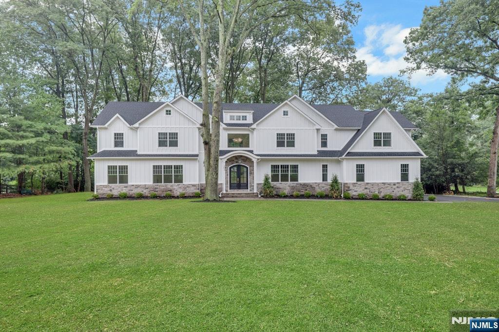 Enjoy the summer on the lake! Lakefront living awaits in the exclusive Shadow Lake Estates of Franklin Lakes. This custom-built Colonial offers 5 bedrooms, 5 full bathrooms, and 2 half bathrooms across three thoughtfully designed levels, with beautiful lake views throughout. Custom finishes and craftsmanship are evident throughout the home. A grand foyer welcomes you into the main level, leading to a formal dining room and a gourmet chef's kitchen complete with center island and pantry. The grand living room, anchored by a gas fireplace, offers a warm and inviting space for everyday living and entertaining. A guest suite with a private en-suite bath completes the first floor, ideal for visitors or extended stays. Upstairs, the luxurious primary suite features a custom-built walk-in closet and a spa-inspired bathroom designed for everyday relaxation. Three additional bedrooms, each with en-suite baths and walk-in closets, complete the upper level. The finished lower level adds even more living space, with a recreation room, media lounge, full bathroom, and ample storage throughout. Residents enjoy exclusive, membership-based lakefront amenities including a clubhouse, pool, boating, tennis, pickleball, basketball courts, and scenic walking trails. Ideally located just minutes from shopping, dining, and everyday conveniences, this home offers the best of lake life and everyday ease.