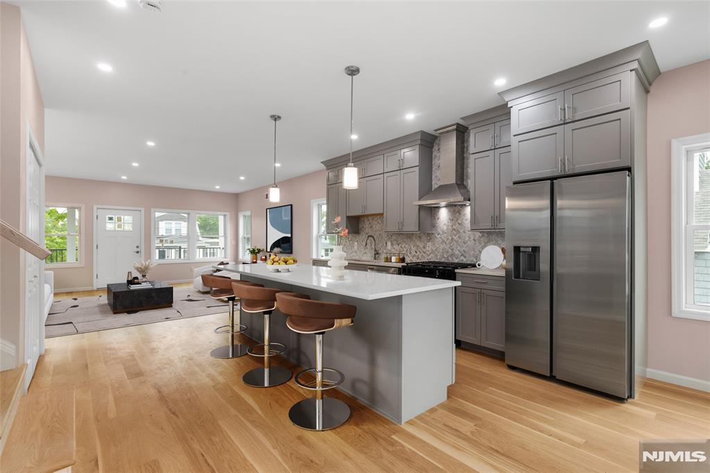 COASTAL LIVING WITH A NYC SKYLINE BACKDROP! Newly raised and built from the ground up, this stunning 5-bedroom, 3.5-bath home offers luxury, space, and unforgettable views overlooking Ideal Beach. Step onto either of two private balconies and take in sweeping views of the bay and iconic NYC skyline. Inside, discover gleaming hardwood floors, beautiful custom cabinetry, a spacious open-concept design, and 3-zone central air for year-round comfort. Generous living space across multiple levels makes this home perfect for entertaining, relaxing, or simply enjoying life by the water. Just moments from the beach and the best of the Bayshore, this is coastal living at its finest. Morning coffee with a view, beach days, and skyline sunsets from your own balcony. Minutes from Seastreak ferry to NYC.