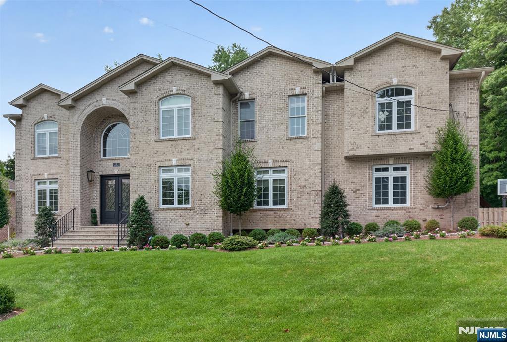 Welcome to luxury living on Demarest's prestigious East Hill. Built in 2013 and meticulously maintained, this exceptional custom residence offers approximately 7,100+ of elegant living space across 3 floors. Featuring 5 spacious bedrooms and 6.5 bathrooms, 3 car garage, each upstairs bedroom enjoys its own private en-suite. The luxurious primary suite offers heated bathroom floors, custom duel walk in closets, motorized shades, and convenient second-floor laundry. The chef's kitchen showcases premium quartzite countertops extending into the butler's pantry, custom cabinetry, and opens seamlessly to the dramatic great room with soaring ceilings, designer fireplace, and motorized shades. Throughout the home you'll find extensive custom millwork, Phillip Jeffries wallcoverings, custom Roman shades, and designer finishes. The spectacular lower level includes a custom bar, theater/game room, fitness studio, full bath, and flexible guest or recreation space. Outside, enjoy a private backyard retreat with professional landscaping, mature trees, paver patio, bluestone walkways, gas fire pit, outdoor sound system, and landscape lighting. Additional amenities include a whole-house generator, central vacuum, water softener, mulit zone heat/central air, underground sprinklers, built-in garage storage, and Ring security system, Ideally located just minutes from NYC, this remarkable home perfectly blends luxury, comfort, and convenience.