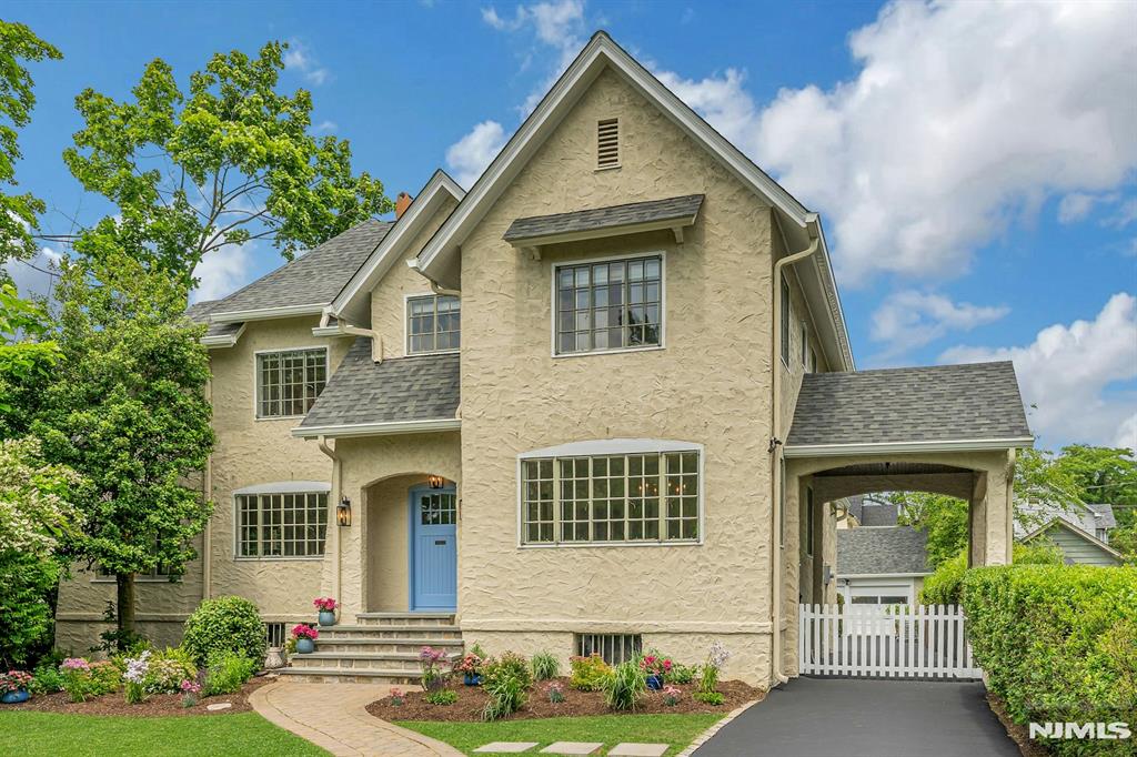 Set along one of Montclair's most picturesque streets and directly overlooking Edgemont Park, 9 Parkway is a rare park-front residence where daily life is framed by pond views, winding paths, fountains, and a lush, ever-changing landscape. Thoughtfully updated and full of warmth, character, and architectural charm, the home is designed for modern living with a flowing layout and large windows throughout that flood each room with natural light while capturing serene park and garden views. At the heart of the home is a beautifully renovated kitchen with a striking nine-foot center island, upscale appliances, and abundant workspace, opening seamlessly to the family room both with direct access to the backyard. Spacious living and dining rooms provide welcoming gathering spaces, while a cozy den offers flexibility as a home office or library. Upstairs, four bedrooms and three updated baths include a serene primary suite with a renovated spa-inspired bath and walk-in closet, along with a newly reimagined ensuite bedroom and convenient second-floor laundry. Recent improvements including a new roof and fresh interior and exterior paint offer peace of mind and move-in-ready ease. Outside, the backyard unfolds as a private botanical sanctuary with mature plantings and native gardens. All just moments from Watchung Plaza's NYC-direct trains, shops and cafes and schools. 9 Parkway offers the rare combination of park-front serenity and everyday convenience in the heart of Montclair.