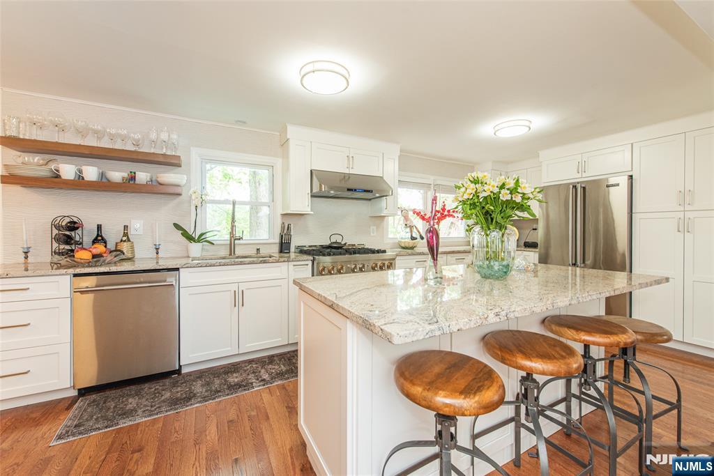 Nestled on a quiet street in the sought-after town of Mahwah, this 2025 newly renovated & thoughtfully expanded 1,530 sq ft 3BR / 2FB home is sure to impress. Upon entering, a sun-drenched Living Room sets the tone, while hardwood floors flow effortlessly into the banquet-sized Dining Room. Imagine preparing your favorite dish in the MEIK complete w/ SS appliances, soft-close cabinetry, granite countertops, Viking fridge & Porcelanosa backsplash. The main level is complete with a Full Bath & access to the fully insulated garage. Renovated & expanded in 2025 w/ a reimagined layout, the home features updated electric & plumbing, a fully renovated kitchen & baths, upgraded structural beams, ductless AC, & a fully permitted addition that enhances the footprint with an enlarged Dining Room, attached Garage & relocated upper-level Laundry, creating seamless, modern living space. Upstairs you'll find Laundry, a brand new Full Bath, Primary Bedroom & 2 additional Bedrooms with ample closet space & custom built-ins. The Basement offers a blank canvas for Recreation Room, Gym, Office or Storage. Further highlights include brand new driveway, 2025 appliances, 2-zone heat, Andersen windows & smart-home features. Outdoor features include patio, expansive side yard & private setting ideal for entertaining. Close to top-rated schools, parks, shops, LOW TAXES & EZ NYC commute. Furnishings may be available for purchase, please inquire.
