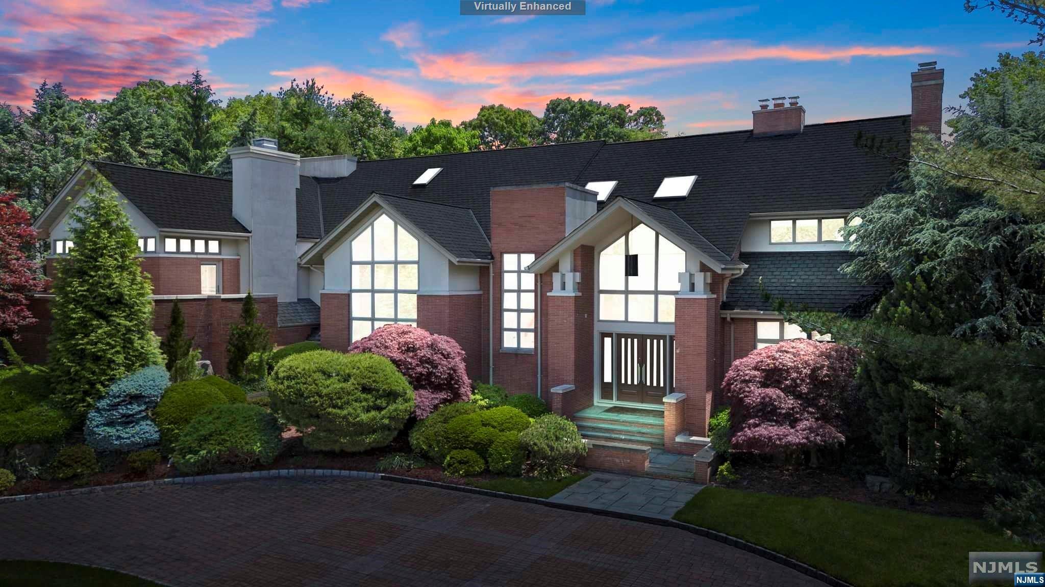 Step into luxury living at its finest with this breathtaking estate nestled on an elevated and highly sought location in East Hill Cresskill. This expansive and architectural masterpiece boasts 6 bedrooms and 6.5 bathrooms with high ceilings and natural light from every level. From the grand foyer to the gourmet kitchen with state of the art newer appliances, expansive great room surrounded by floor to ceiling windows, family room and library, no detail has been overlooked. The stunning backyard features a free form newly resurfaced gunite pool with custom rock formation wall and lush landscaping. Enjoy panoramic western views of the sunset from the private terrace in the lavish mezzanine level master bedroom suite with a fireplace and private stone patio, large closets and huge spa-like bathroom. Convenient access to NYC with top rated schools in Bergen County... not to be missed!
