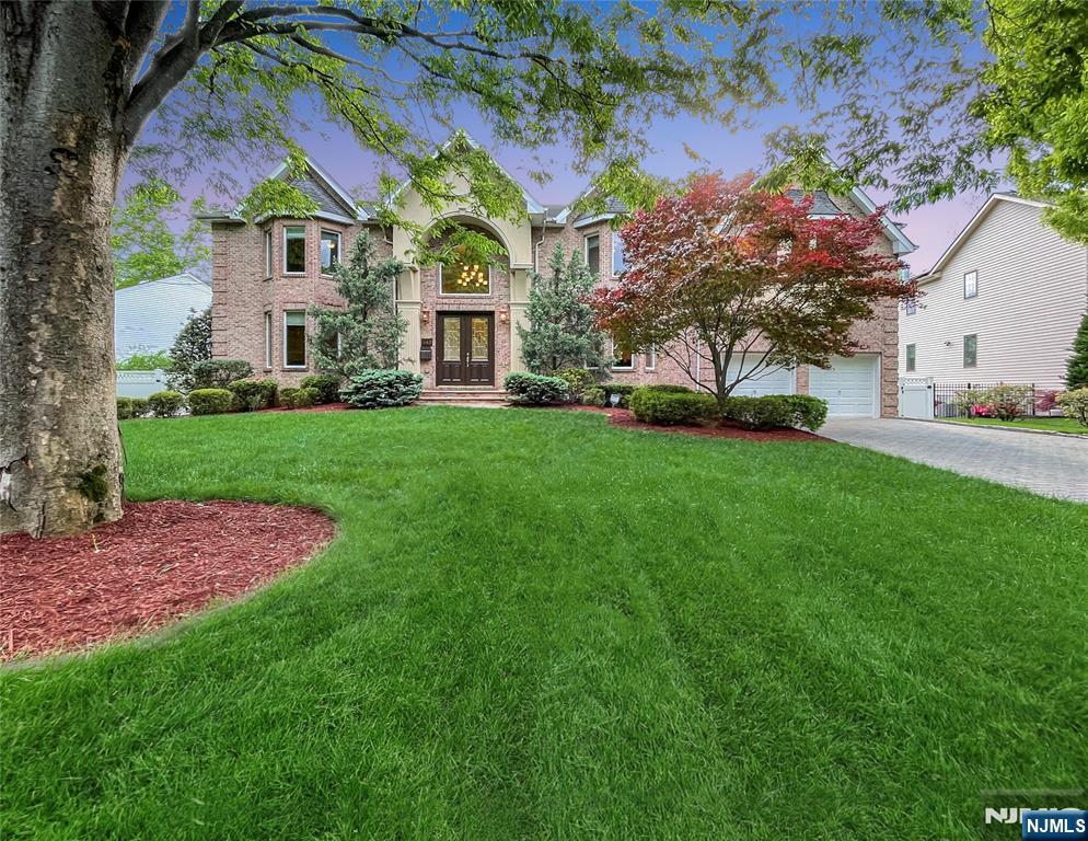 THIS IS A MUST-SEE! This Colonial home offers exquisite suburban elegance in highly sought-after Paramus. The journey begins in an airy, two-story foyer, surrounded by a grand formal dining room and quiet den. The heart of the home is the breathtaking great room, featuring soaring vaulted ceilings and an elegant fireplace. Ideal for guests, a first-floor bedroom with private en-suite is conveniently located nearby. The eat-in kitchen is a culinary dream, boasting modern appliances, island, and expansive counter space. This main level is completed by a dedicated home office, a powder room, a laundry room, and access to the finished two-car garage. The backyard is a private oasis with an open field behind the fenced-in property. Features include a modern Trex deck overlooking a sparkling saltwater swimming pool and spa. Upstairs, a catwalk landing offers dramatic views of the levels below. The layout includes two generous bedrooms sharing a full bath, plus a third large bedroom with a private en-suite. The crown jewel is the primary suite, a massive retreat with a sitting room, fireplace, tray ceilings, walk-in closets, and a spa-like bathroom with a jetted tub and dual sinks. Finally, the massive basement offers a blank canvas of partially finished spaces perfect for a home gym, theater, wet bar and more. Updates include an infrared alarm system, irrigation system, two A/C units, and newer furnace. This must-see residence perfectly combines grand scale with functional luxury.