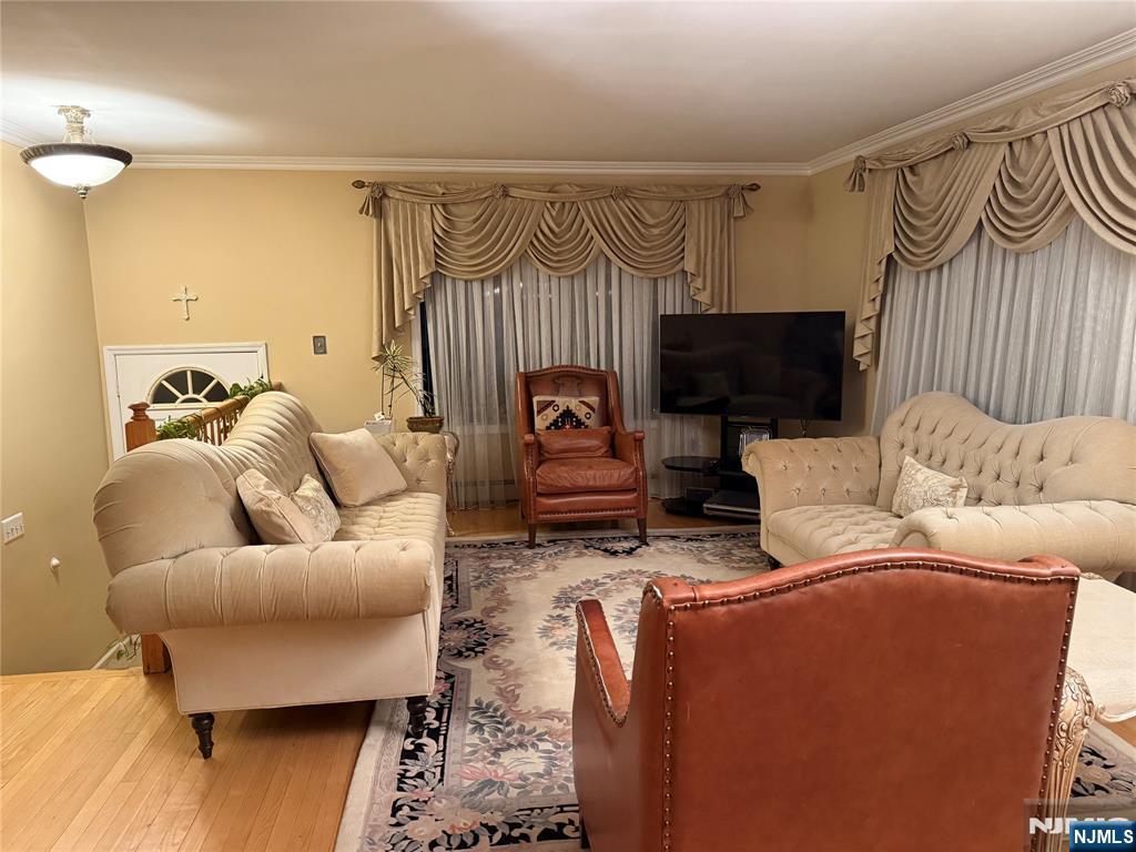 Spacious and beautifully maintained, this three-level townhouse-style apartment offers the perfect combination of comfort and convenience. The main level boasts a generous open-concept living and dining area, a modern eat-in kitchen with recent renovations, a private deck, a stylishly updated half bath, and in-unit laundry. Upstairs, you'll find a spacious primary suite with a private bathroom, two additional well-sized bedrooms, and a second full bath. Parking includes one garage space with an attached storage room, plus an additional driveway spot. Residents also enjoy shared access to the backyardâ€”ideal for relaxing or entertaining. Conveniently located with an easy commute to New York.