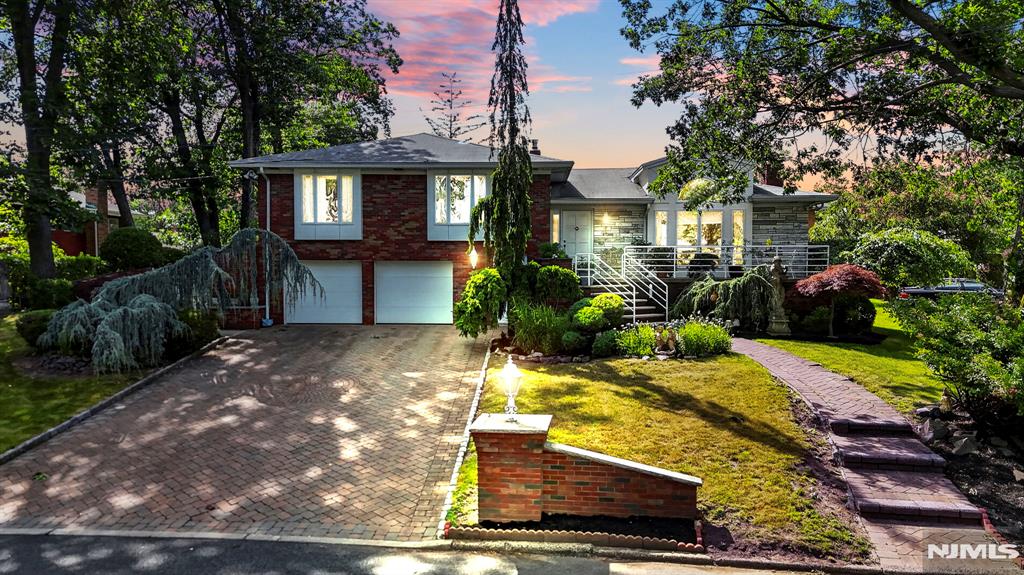 Set on a quiet cul-de-sac in Fort Leeâ€™s highly sought-after Bluffs section, this well-maintained residence offers a peaceful residential setting with excellent convenience. Surrounded by mature landscaping, the home features inviting curb appeal with a paver driveway, attached two-car garage, and private outdoor space. The main level offers a bright, spacious layout with a welcoming foyer, formal living and dining areas, and a sun-filled family room with vaulted ceilings, skylights, fireplace, and access to the patio. The eat-in kitchen provides generous cabinet storage and a functional layout for everyday living. Upstairs, youâ€™ll find three bedrooms, including a primary suite with a private bath, plus an additional full bath. The ground level includes a private office, laundry area, powder room, and direct garage access, while the finished lower level offers flexible bonus space for recreation, entertaining, storage, or future customization. Close to dining, shopping, parks, schools, and convenient NYC transportation.