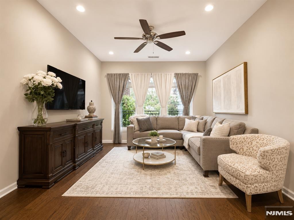 Welcome to this beautifully updated residence at The M at Englewood South. This 2-bedroom, 2.5-bath home offers approximately 1,410 sq ft of living space with a bright, open layout, 10-foot ceilings, premium hardwood floors installed just a year ago, and freshly painted interiors, giving the home a like-new feel. The kitchen features granite countertops, stainless steel appliances, and a breakfast bar overlooking the spacious living and dining area. The primary suite includes a walk-in closet and a private bath. The uniquely designed second bedroom offers flexibility for a variety of furniture layouts, while the generously sized den with double-door closets can easily serve as a home office or guest room. Additional highlights include ample closet space, a recently updated water heater, one indoor garage parking space, one additional assigned outdoor space, and plenty of guest parking. Residents enjoy a renovated clubhouse, updated lobby, and outdoor pool. The monthly HOA covers water, heat, cable/internet, parking, and access to amenities, with only electricity paid separately. Conveniently located near major highways, shopping, dining, parks, Downtown Englewood, and the George Washington Bridge, this home offers exceptional flexibility and convenience in one of Englewood's most desirable communities.
