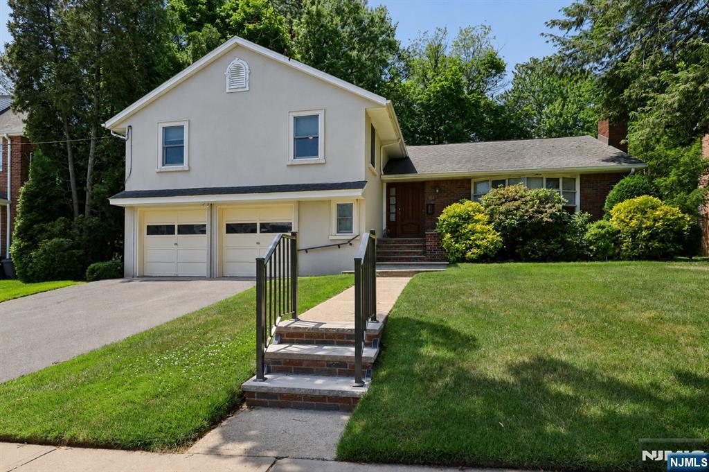 Welcome to this spacious and well-maintained 6-bedroom split-level home, perfectly situated on a 75' x 120' property in the heart of Teaneck. Offering plenty of room for comfortable everyday living and entertaining, this home features a flexible layout designed to meet a variety of needs. The main level includes a spacious living room, a large formal dining room, an updated eat-in kitchen with ample cabinet and counter space, two sinks, double ovens, a warming drawer and a convenient powder room. Upstairs, you'll find four generously sized bedrooms and two full bathrooms. The ground level offers even more versatility with an additional bedroom, a den or home office, a full bathroom, laundry area, and direct access to the attached two-car garage. The fully finished basement provides exceptional bonus space, featuring a spacious recreation room, a sixth bedroom, a full bathroom, and abundant storage. Conveniently located near parks, shopping, houses of worship, and transportation, this inviting home offers the perfect combination of space, comfort, and location.