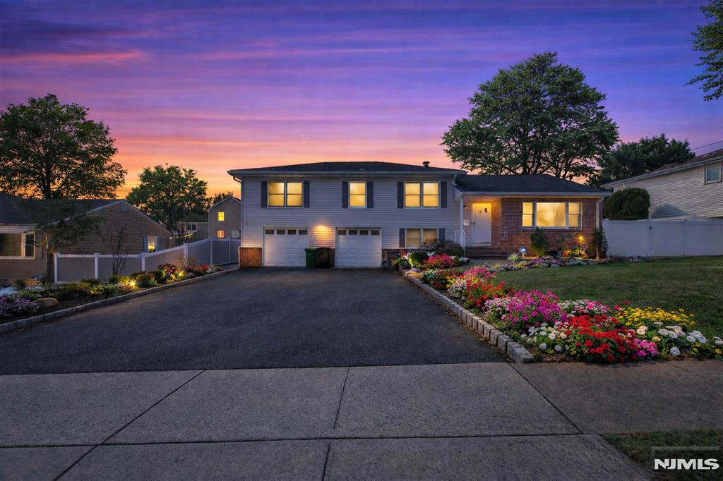 Set on quiet cul-de-sac in Paramus, this renovated & expanded split-level home offers comfortable living w/a practical & flexible layout. The property sits on an approximately 88.5' x 106' lot, providing a well-sized setting in a peaceful residential location. The home features a large living & dining room w/vaulted ceilings & expanded family room w/gas fireplace & sliding glass doors to the private back patio (w/ bbq gas line) & fenced in yard. Upstairs is a generous primary suite w/walk in closet & renovated marble & porcelain bathroom, plus 2 more large bedrooms & a 2nd full bathroom. At grade level, you'll find a conveniently located half bath & laundry room that offers potential for expansion to a full bathroom if desired. There is also a bonus room that could be used as a 4th bedroom, office, or playroom and, lastly, an oversized 2 car garage. A finished lower level adds additional living space & storage, ideal for recreation, media or a secondary family area. A separate bonus room provides further flexibility & can easily function as a home office, music room or guest space depending on needs. Updates include new roof (2021) & water softener system (2017) w/new filter installed (2022). Located on a low-traffic cul-de-sac while remaining close to Paramus shopping, dining, parks & major highways, this home offers a balance of privacy, convenience, and adaptable living space. https://newjerseyproper.com/mls-206-harwood-pl-paramus-nj/