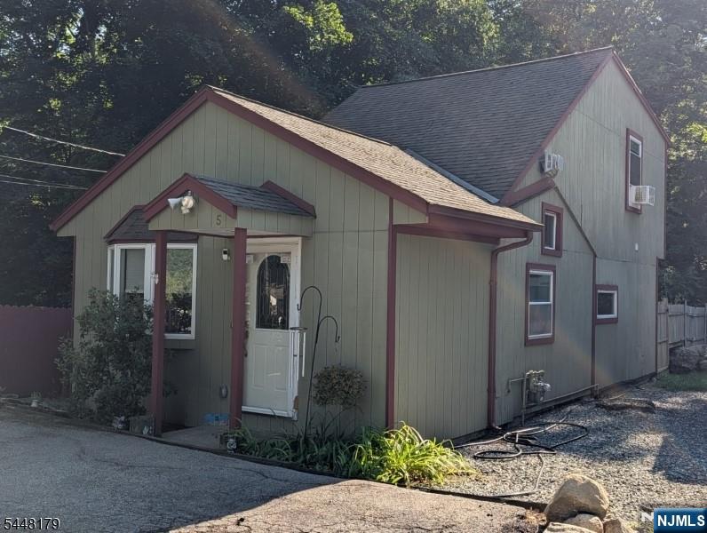 Adorable lake cabin/cottage located in small lake community in lower West Milford with easy access to routes 23 and 287. Backs up to parkland. Located very short walk to the private community beach. Dead end road. King size primary bedroom with vaulted ceilings and 2 closets. Access to huge walk in attic. Second bedroom is on the same level with vaulted ceilings as well. Main level features cozy log living room with natural gas fireplace/stove that current owner uses to heat the entire house, vaulted ceilings, updated kitchen with small dining area, updated tile bath, laundry room with room for full size units, large front entry room with large closet currently used for home office. Back yard features large finished heated shed with electric, double doors, pull down attic, exhaust fan. Was used by prior owner as shop for working on his motorcycle. Yard is mostly fenced in and is all gravel as current owner has 2 dogs. This house has been lovingly maintained by the current owner for over 20 years.