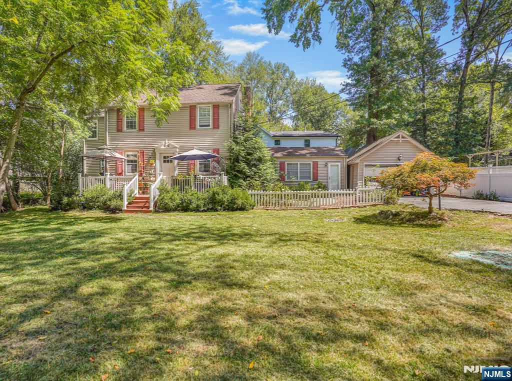 Welcome to this charming Colonial in Closter NJ one of the most sought after towns in Bergen County. Located on a quiet dead end street lined with mature trees sitting on .23 acres this 3 bedroom 2 bath home offers comfort space and many updates throughout. Upstairs you will find three spacious bedrooms and a full bath. The first floor features a large bright living room, kitchen and a versatile bonus room perfect for a home office or playroom as well as a den/family room extension with a full bath which can be used as an extended guest or in law suite. The updated kitchen bathrooms and floors bring a fresh modern feel to the timeless Colonial layout. The property includes a huge yard ideal for entertaining gardening or relaxing along with a wide driveway that provides plenty of parking. Close to shopping dining public transportation and parks this home combines suburban tranquility with everyday convenience. At this price point in this location this property won't last come check it out!