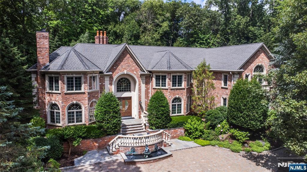 No detail overlooked and no expense spared, this opulent custom built home awaits its lucky new owner. Welcome to 6 Adams Road in the prestigious and highly sought-after Saddle River, New Jersey. Behind the gates stands this grand residence, perfectly nestled on 2 acres of lush land surrounded by your personal award-winning jungle oasis. Enter through the grand double doors and be greeted by a sweeping dual staircase that sets the stage for this palatial residence. The dramatic double-height Great Room wows with hand-painted murals and intricate wall finishes, while soaring windows frame enchanting views of your own private resort-style sanctuaryâ€”with lush landscaping, a cascading waterfall pool, and tranquil fish pond. The chefâ€™s kitchen is a culinary masterpiece, outfitted with top-of-the-line appliances including Sub-Zero refrigerator, multiple Wolf ovens, dual Miele dishwashers, and two sinks for effortless entertaining. Custom cabinetry and designer finishes complete the space. Upstairs, five generously sized en-suite bedrooms provide comfort and privacy, with the palatial primary suite occupying its own wing, featuring a private sitting area and a spa-inspired bath that feels indulgent. The lower level is a haven for entertaining, boasting a full-sized gym, an eight-seat movie theater, a billiards room, and a temperature-controlled Tuscan-inspired wine cellar with storage for over 400 bottles.