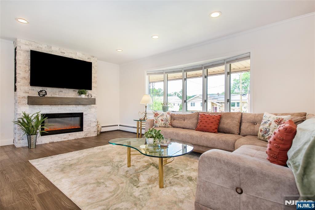 THIS IS IT! Multi-generational living at its best! Offering two private levels of living space with ideal in-law suite. This beautifully renovated home combines modern updates with a highly sought-after Montclair Hts location. The main level features a stunning eat-in kitchen w quartz countertops, SS appliances, 42" cabinets, and center island. The dining room opens to the kitchen and spacious living room, creating the perfect flow for gatherings. A large bay window fills the living room w natural light, while the newer fireplace adds warmth and charm. The primary bedroom offers a renovated private full bath. Two additional bedrooms and a second renovated full bathroom complete the main level. The private ground level, with separate entrance, offers exceptional flexibility with a fourth bedroom, third renovated full bath, family room with sliders to the yard, office, -ideal for extended occupants or guests. Enjoy outdoor living with a covered front porch and a private backyard with mature landscaping, pool, storage shed, and covered patio. A newer two-car-wide asphalt driveway leads to a detached two-car garage with epoxy floor and automatic opener. Additional features include recessed lighting, newer flooring, updated electrical panel, Anderson windows, newer central air, and more. Conveniently located near Montclair town center, restaurants, shops, schools, major highways, and NYC transportation. A rare opportunity offering space, flexibility, modern living and location!
