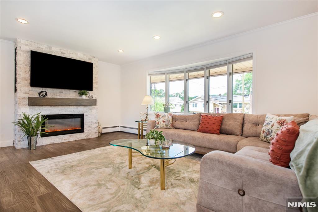 THIS IS IT! Multi-generational living at its best! Offering two private levels of living space with ideal in-law suite. This beautifully renovated home combines modern updates with a highly sought-after Montclair Hts location. The main level features a stunning eat-in kitchen w quartz countertops, SS appliances, 42" cabinets, and center island. The dining room opens to the kitchen and spacious living room, creating the perfect flow for gatherings. A large bay window fills the living room w natural light, while the newer fireplace adds warmth and charm. The primary bedroom offers a renovated private full bath. Two additional bedrooms and a second renovated full bathroom complete the main level. The private ground level, with separate entrance, offers exceptional flexibility with a fourth bedroom, third renovated full bath, family room with sliders to the yard, office, -ideal for extended occupants or guests. Enjoy outdoor living with a covered front porch and a private backyard with mature landscaping, pool, storage shed, and covered patio. A newer two-car-wide asphalt driveway leads to a detached two-car garage with epoxy floor and automatic opener. Additional features include recessed lighting, newer flooring, updated electrical panel, Anderson windows, newer central air, and more. Conveniently located near Montclair town center, restaurants, shops, schools, major highways, and NYC transportation. A rare opportunity offering space, flexibility, modern living and location!