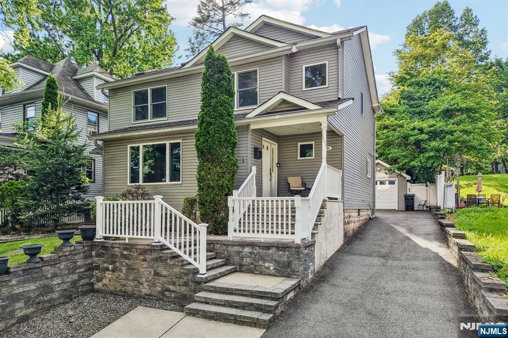 Welcome Home to this truly one-of-a-kind property in the heart of Nutley, featuring an exceptionally rare 258-ft deep lot, an outdoor space almost unheard of in town. Designed for both everyday living and entertaining, this expansive property offers multiple outdoor living areas including a large deck with built-in covered hot tub, patio, lounging/dining deck, and an above-ground pool with wraparound deck. The backyard also features a play set, trampoline, storage shed, and incredible space to relax or entertain. An oversized driveway provides ample parking, while the detached garage includes an attached bonus space currently set up as a tiki bar. Inside, the home was fully gut renovated and expanded in 2004 with a bright open-concept layout ideal for modern living. The first floor features a spacious living room, dining area, eat-in kitchen with walk-in pantry, abundant storage, first-floor laundry, deck access, a first-floor bedroom, renovated full bath, and built-in speakers throughout the first floor, outdoor deck, and primary suite. Upstairs offers three generously sized bedrooms, a spacious hallway bath, and a stunning primary suite with soaring ceilings, skylights, office area, walk-in closet with built-ins, and spa-like bath with separate tub and shower. Conveniently located near NYC transportation, parks, shopping, restaurants, schools, and downtown Nutley.