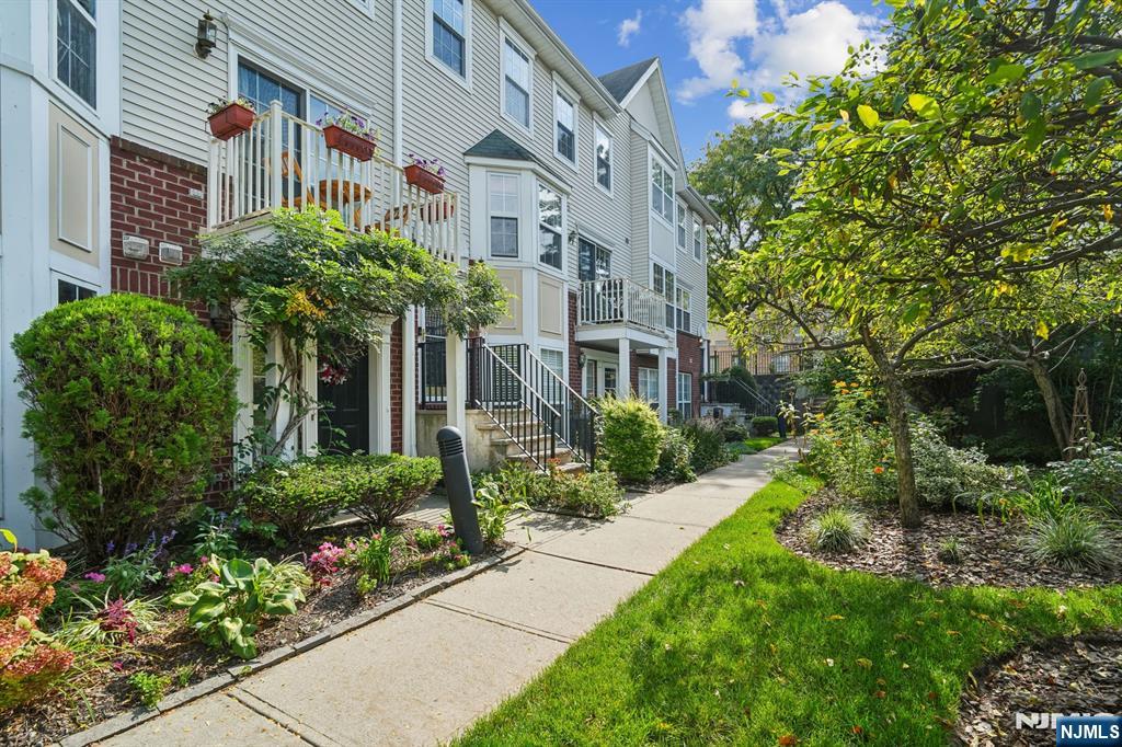 Perfect for Commuters! Discover this expansive, sun-drenched 2-bedroom, 2.1-bath townhouse in a beautifully landscaped complex, located in the heart of downtown Montclair just steps away from the NJ Transit Bay St Station for a seamless NYC commute. The main level features an open floor plan with gleaming hardwood floors, a spacious living room, dining area, and a guest powder room. The renovated kitchen boasts stainless steel appliances, quartz counters, and ample custom white cabinetry, along with a private balcony accessed through elegant French doors. Upstairs, you'll find a hallway full bath and two spacious bedrooms, including a primary suite with an en-suite bath and generous closet space. Enjoy the convenience of in-unit laundry and the community-oriented living experience this residence provides. Immerse yourself in the vibrant Montclair lifestyle, with easy access to local restaurants, shops, the Art Museum, Whole Foods, farmer's market, nearby parks, and a highly sought-after magnet school district. This unit includes 2 assigned parking spots and 2 additional guest passes. Experience the best of Montclair living while maintaining an easy commute to NYC. This townhouse truly has it all and defines "location"!