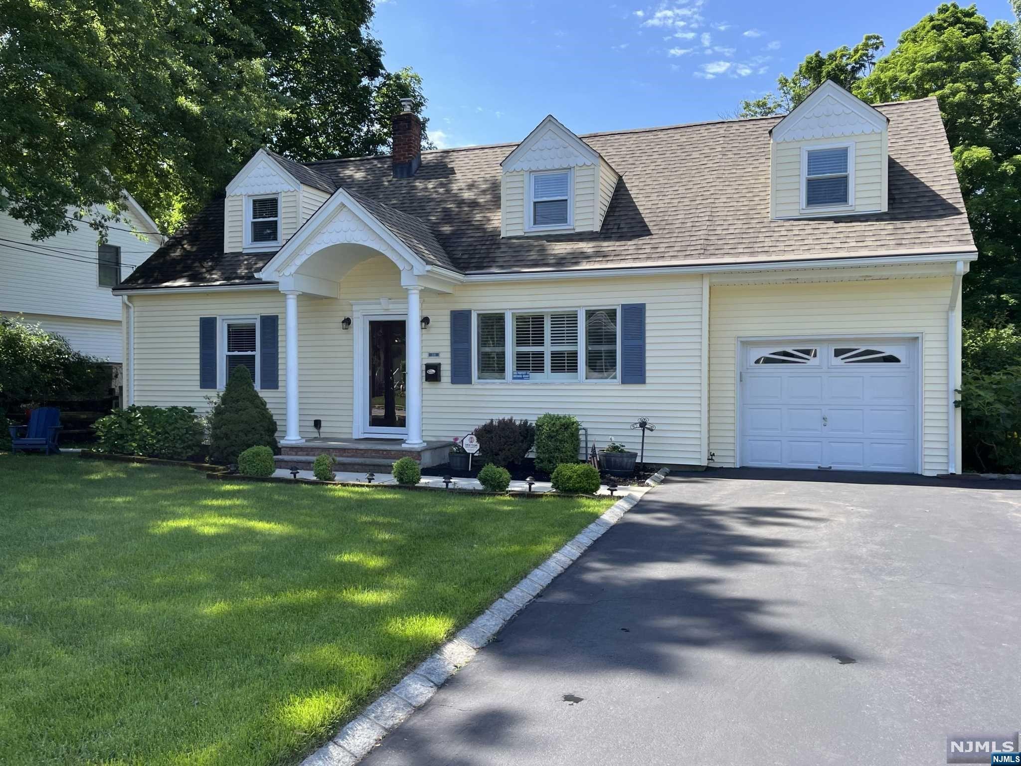 Pride of ownership emanates from this charming and spacious, expanded Cape Cod style home. You will delight in the recently renovated sun-drenched kitchen, with granite countertops, stainless appliances, and a soaring ceiling with skylight. Entertain in the adjacent formal dining room, the cozy living room, or on the Trex deck overlooking this lush property. Two bedrooms and a full bathroom complete this level. The second floor provides a spacious bedroom, a second full bathroom, and home office (or 4th bedroom). The unfinished basement presents generous storage space, and potential additional living space. This home boasts countless upmarket details and upgrades, including gleaming wood floors, smart technology, and new windows. Location! This picturesque home is set on over 1/4 acre of manicured gardens. Just a stone's throw to Ridgewood's top ranked schools, downtown Ridgewood, Ho-Ho-Kus Village and commuter trains.