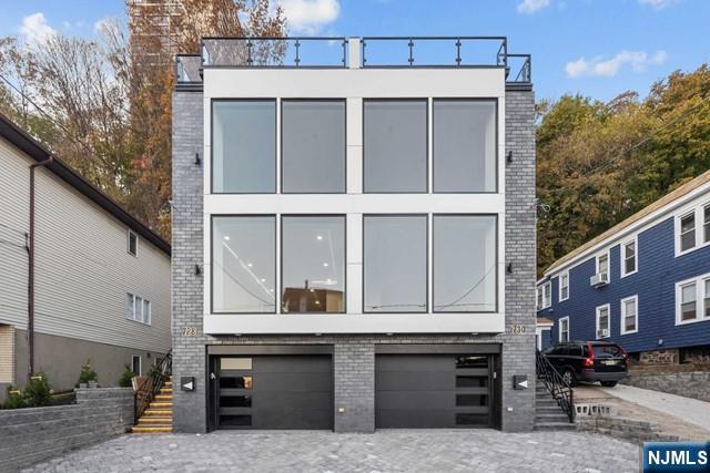 THIS OVERSIZED LUXURY DUPLEX TOWNHOME BUILT IN 2023 IS ONE OF THE LARGEST IN EDGEWATER NEW JERSEY WITH STUNNING VIEWS OF THE NYC SKYLINE AND HUDSON RIVER. APPROX. 4500 SQFT/ 4 LEVELS WITH 9FT CEILINGS/ 4 BEDROOMS / 3 FULL BATHROOMS 2 HALF BATHS AND MAGNIFICENT 1000 SQ FOOT WRAP AROUND ROOFDECK. 2 CAR GARAGE, ANDERSON WINDOWS, PRIVATE ELEVATOR, CUSTOM KITCHEN AND BATHS, CUSTOM GLASS WALLS AND WRAP AROUND KITCHEN ARE SOME OF THE FEATURES INCLUDED IN THIS HOME. KITCHEN WITH PROFESSIONAL GRADE APPLIANCES AND 11 FOOT CENTER ISLAND. LARGE PRIMARY BEDROOM WITH SPA LIKE PRIMARY BATH,. TOP FLOOR HAS ENTERTAINMENT ROOM, WET BAR WITH ACCESS TO ROOF AND BATHROOM. FRONT AND REAR ROOF DECKS, FRONT DECK IS PARTIALLY COVERED AND SET UP FOR OUT DOOR TV