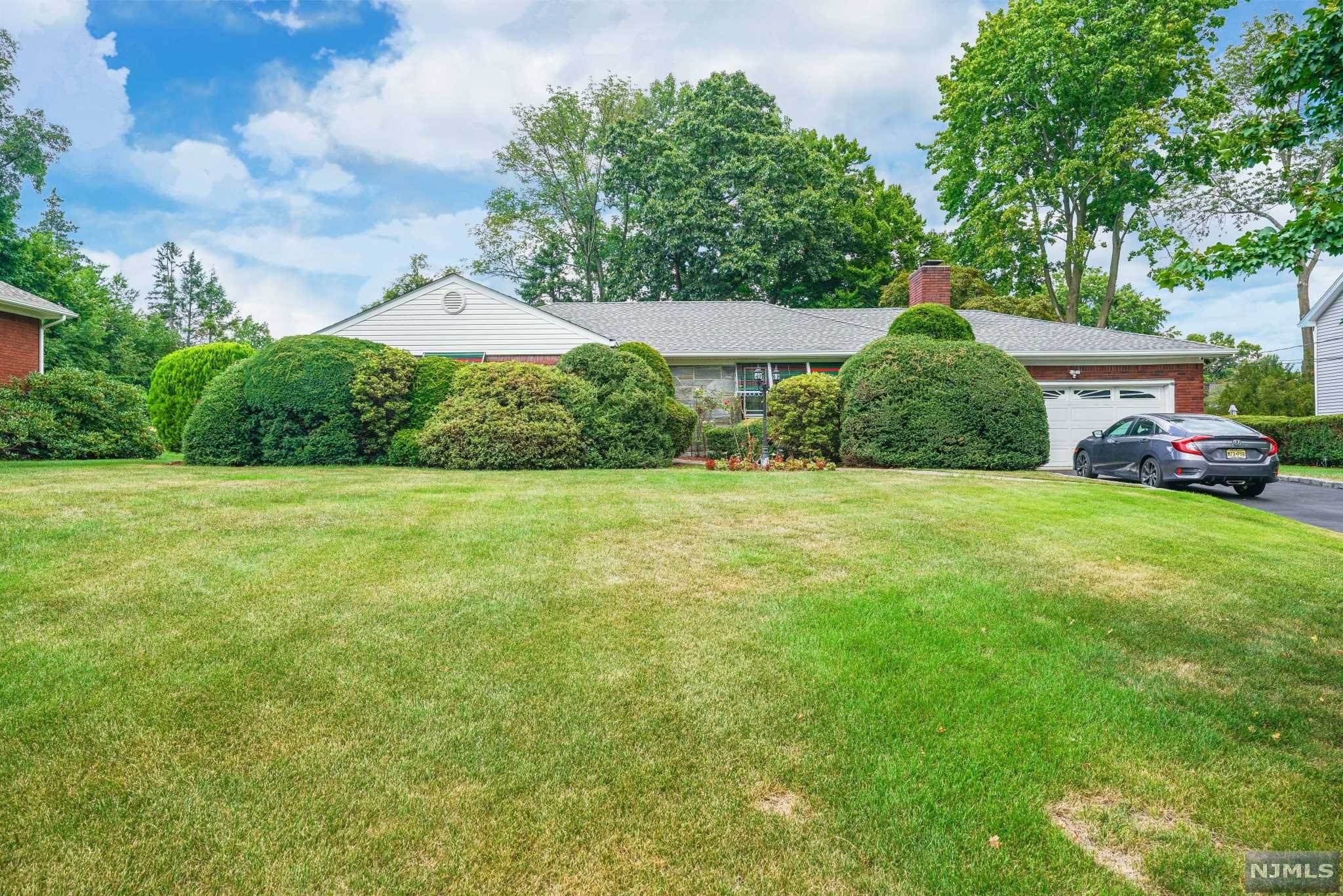 Welcome Home. This 3 bedroom ranch including a fireplace, a built in 2 car garage, an enclosed porch and a full finished basement. The wide open basement includes a bar, bathroom, a laundry room/kitchen area, and a separate room off to the side. Great for entertaining. Step outside to an outdoor oasis with a heated inground pool, a pool house with a sauna and a full bathroom. Dont miss out!