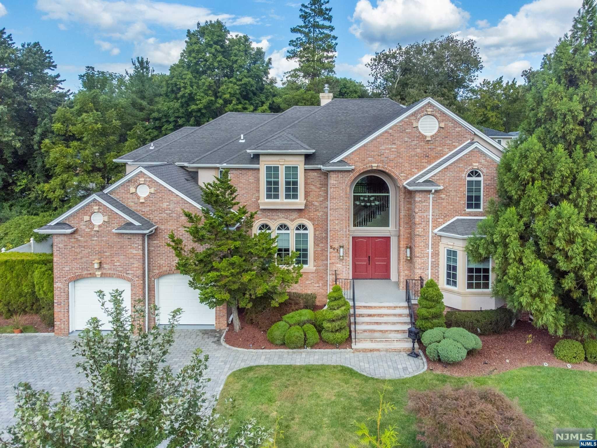 Stunning colonial estate on East side of Closter walking distance to downtown. Grand 2 story entry foyer with radiant heated floors and chandelier. First floor boasts formal living room, Formal dinning room, powder room, home office/bedroom with full ensuite, laundry room and more. Modern eat in kitchen has granite counters, custom cabinetry with oversized appliances and radiant heated floors. Spacious kitchen shares a gas fireplace with the connecting Great Room. This massive sun filled Great Room has 25ft ceiling and open hallway/balcony from upstairs. Once upstairs you will find 2 bedrooms with a Jack and Jill FBTH. A Junior Suite with ensuite. Master Bedroom has tray ceiling and 2 walk in closets. Over sized Master bath has jacuzzi tub and tiled shower, 2 vanities, separate area for toilet and bidet and radiant heated bathroom floor. Basement is fully finished with FBTH. Backyard has massive paver patio and outdoor kitchen. Sprinkler system and rose bushes included.