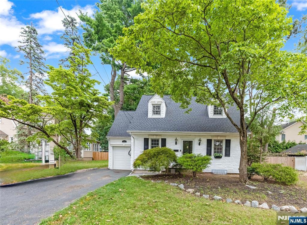 Welcome to this very well maintained Charming Stone-Faced Cape Cod Colonial: A True Gem located in New Milford known for its charismatic homes, quaint old world ?charm, updated with more modern amenities. The first floor features a formal dining room, where a custom wood and marble gas fireplace sets the stage for memorable gatherings. The heart of the home is the gorgeous granite kitchen, featuring a brand-new stove and dishwasher in 2025. Its open floor plan seamlessly connects to a spacious eating area, oversized Island. The ?light and ?airy family room dazzles with soaring ceilings adorned w/ rustic wood beams, skylight & large windows that frame views of the picturesque, park-like backyard. Three bedrooms & a full bath located on the 2nd Fl. Fully finished basement offers additional living space, abundant storage and houses new mechanicals: water heater, updated steam pipes, &new washing machine, a brand-new roof (2025) Ensuring peace of mind for years to come Step outside to discover a breathtaking backyard oasis, accessible through glass sliders that lead to an oversized deckâ€”perfect for summer barbecues and outdoor relaxation. The newly fenced (2025) yard provides plenty of room for entertaining in your own peaceful haven. One-car attached garage. Situated on an oversized lot. NYC Commers delight, via train to the PATH or bus service along River Road., all the amenities and conveniences that New Milford has to offer.