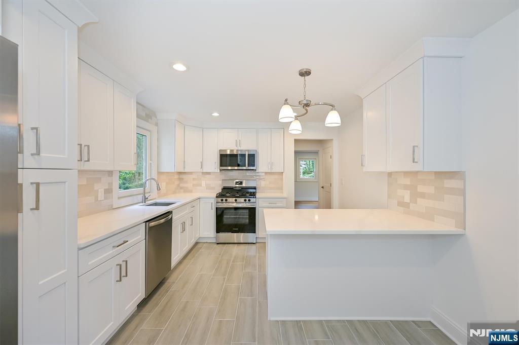 You'll be impressed by this beautifully renovated and larger than expected light filled home offering three levels of thoughtfully designed living space including a walk out ground level. Every inch has been transformed through a complete renovation with quality craftsmanship and stylish finishes throughout. Highlights include a stunning new kitchen with Shaker cabinetry, quartz countertops, and stainless steel appliances and three new bathrooms. The first floor features spacious living and dining areas, a new kitchen, bedroom, and a beautifully appointed full bath. Upstairs offers two additional bedrooms, and a new full bath with a walk-in shower. The finished lower level expands the living space with a large recreation room featuring french doors to the patio, a full bath, a bedroom or office, and laundry room, providing excellent flexibility for entertaining, guests, or working from home. A rare opportunity to own a fully renovated home on a larger lot (11,000+sq/ft) in a prime location. just unpack and enjoy!