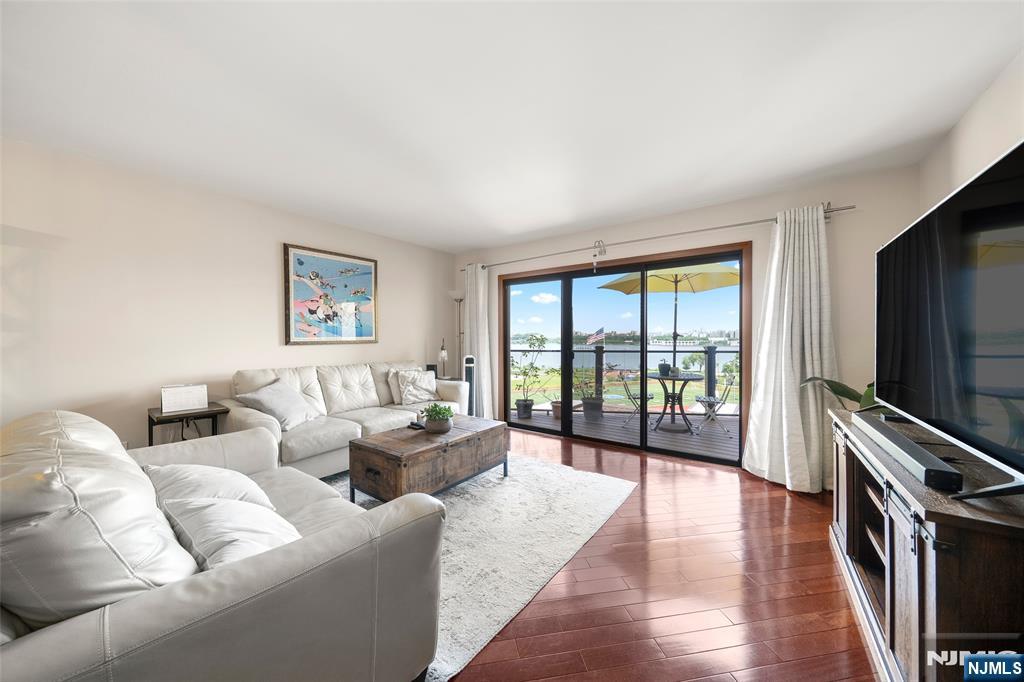 Welcome to this beautifully renovated California-style townhome offering gorgeous NYC views and approx. 1,408 sq.ft. of exceptional living space in the heart of Edgewater. This unique STREET-level residence features 2 bedrooms, 1.5 baths, & a fully enclosed loft ideal for a home office, guest rm, or creative flex space. Renovated in 2021, the home showcases quality upgrades & thoughtful improvements throughout. The first fl features a newly renovated kitchen w/elegant marble flooring, while the living room offers warm hardwood floors and abundant natural light. Bathrooms are beautifully finished in marble, including the 2nd fl primary bath w/both a soaking tub and separate stand-up shower. Major updates include replaced windows, electrical systems and custom closet organizers throughout, including attic storage. Enjoy year-round comfort w/ a young dual-zone HVAC system controllable remotely via app. The exterior improvements including the roof, balcony, and exterior renovations have already been completed through the special assessment, adding tremendous value and peace of mind for the next owner. Relax outdoors on the private balcony with Trex flooring while enjoying beautiful skyline views. The finished loft creates the perfect work-from-home setup or bonus living area. Conveniently located just minutes from NYC ferry service, express buses, shopping, restaurants, and waterfront parks, this move-in-ready home offers the perfect blend of comfort, style, and commuter's dream.
