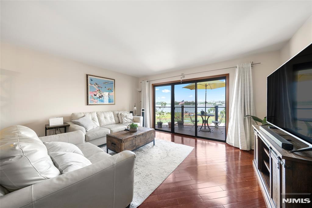 No Special Assessment- Seller Paid! Welcome to this beautifully renovated California-style townhome offering gorgeous NYC views and approx. 1,408 sq. ft. of exceptional living space in the heart of Edgewater. This unique street-level residence features 2 bedrooms, 1.5 baths, & a fully enclosed loft ideal for a home office, guest room, or flex space. Renovated in 2021, the home showcases quality upgrades & thoughtful improvements throughout. The first floor features a renovated kitchen with elegant marble flooring, while the living room offers warm hardwood floors and abundant natural light. Bathrooms are beautifully finished in marble, including the second-floor primary bath with both a soaking tub and separate shower. Major updates include replaced windows, electrical systems, and custom closet organizers throughout, including attic storage. Enjoy year-round comfort with a young dual-zone HVAC system controllable remotely via app. Exterior improvements, including the roof, balcony, and building renovations, have already been completed through the special assessment, adding value and peace of mind. Relax on the private Trex balcony and enjoy skyline views. The finished loft is ideal for a home office or bonus space. Conveniently located near NYC ferry service, express buses, shopping, restaurants, and waterfront parks. Low property taxes and a highly regarded school system make this home an exceptional opportunity.