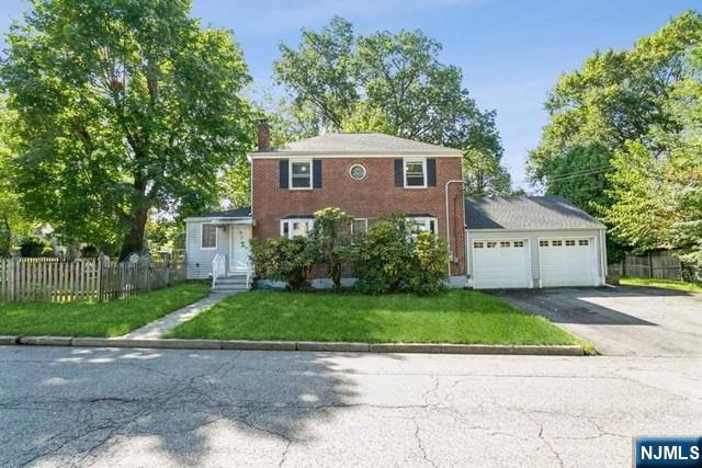 Beautifully renovated 4 bedroom, 2.5 bath home on a lovely street in sought-after Tenafly. With gleaming hardwood floors throughout, first floor features formal living room with wood burning fireplace, newer eat-in kitchen with granite counters and stainless steel appliances, bright formal dining room and den/bedroom, full bath, mud room and attached 2-car garage. Two bedrooms and a full bath complete second floor. Full finished basement features rec area, laundry and half bath.