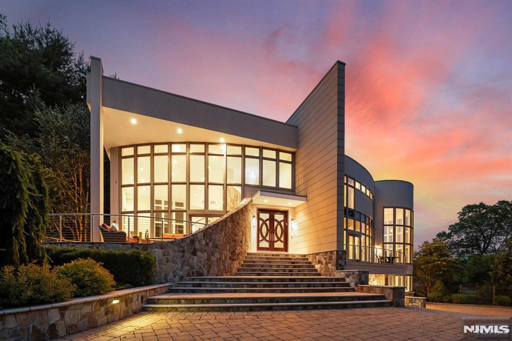 Escape to Chateau Moderna-the perfect juxtaposition btwn mountain & water located in the magical sanctuary of Smoke Rise, renowned for its privacy & natural beauty. Explore this impressive 8,000+ sq ft custom home panoramically situated on 3.79 acres of manicured bliss, featuring 5 beds, 6.2 baths, & many luxurious amenities such as paver driveway, koi/lily ponds, & beautiful deck overlooking the landscaping of constant, new bloom. Enjoy a contemporary masterpiece drenched in complete sunlight creating spacious living w custom features:Swarvoski-crystal drs, modern window trmnts, automated blinds, gourmet EIK, conservatory/office, gym, sauna, wine cellar, & theatre - all complemented by a priv. backyard oasis w exquisite pool w hot tub, waterfalls & firepit in an exclusive lakefront location.Experience resort-style living in a private community, which includes the Smoke Rise Inn, tennis, playgrounds & beach-ready for swimming, boating & fishing all w convenience of 24-hr security.