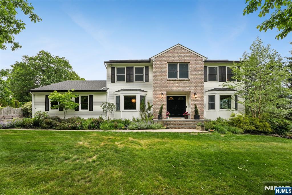 Nestled on almost 1/2 acre, surrounded by trees, "privacy, serenity, and peaceful" are what come to mind when describing this fabulous home. Charm and character are coupled with modern updates that make this center hall colonial classic yet timeless. Highlights include large, spacious rooms, hardwood floors, updated bathrooms, a first-floor bedroom/office, and a convenient laundry room, Andersen windows, including 3 bay windows, French doors from the family room to the deck, and 4 large bedrooms upstairs with ample closets. The lower-level walk-out to the backyard has a private entrance and is fully finished with a den (or 7th bedroom), a guest/maid room, a full bathroom, a massive rec room, a storage/workroom, plus loads of closets & storage. The HUGE fenced-in backyard is perfect for baseball, soccer, or football games, and can easily accommodate a pool or playset. The 60 ft deck provides a perfect spot to enjoy AMAZING VIEWS, especially for area fireworks, BBQs, or simply a quiet spot to relax! Located near parks & recreation, easy access to major highways & many NYC commuting options.