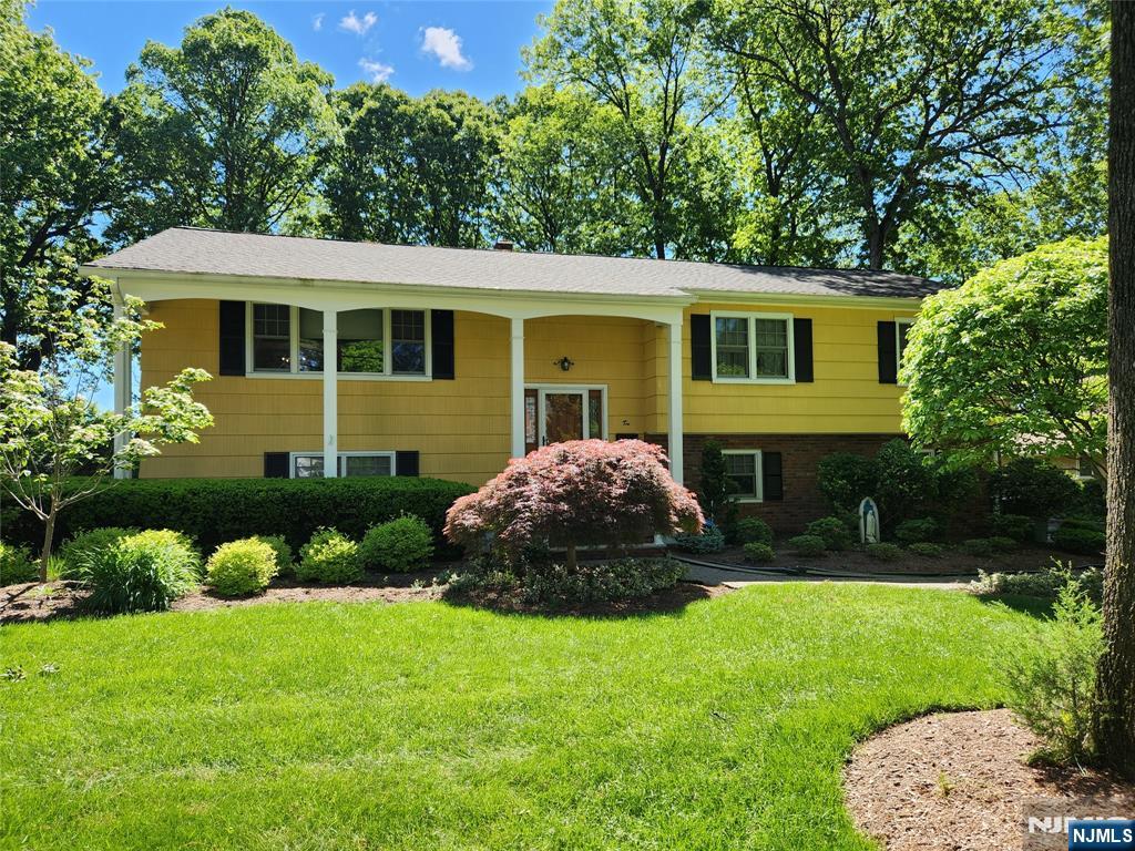 Pride of ownership shines throughout this move-in ready gem of a home. Great curb appeal w/a front open porch. Sought after, quiet street. 4 spacious bedrooms. 2.5 baths. Incredible, oversized yard is like your own personal park & perfect for adding a pool. Entry foyer. Formal living & dining room w/hardwood floors & picture frame moldings. Expanded MEIK w/dining area & sgd to a spacious deck. Updated hall bath (sot). Large Primary BR w/dressing area & full Mbth. 2 additional BRs Ground flr Family Rm w/raised hearth brick wall FPL and sliders to large patio. 4th BR, updated powder room, laundry rm w/sink & utility room. Spacious rooms & lots of storage throughout. Whole house generator. Central Air. 3 zones gas, hw, bb heat. Updated Timberline roof. Step outside to the true highlight of the property, a gorgeous, oversized and level yard that feels like a private retreat. Whether you're hosting a summer BBQ, gardening or simply relaxing on the deck or patio, this outdoor space offers endless possibilities. Professional landscaping. U/G sprinklers 2 car attached garage w/EE openers. Security System Hardwood floors under the carpet upstairs. Close to local DiMaggio park, the new Valley Hospital, Route 17 & GSP & more. Home is well maintained w/no known issues but to be sold as-is, including driveway & exterior.