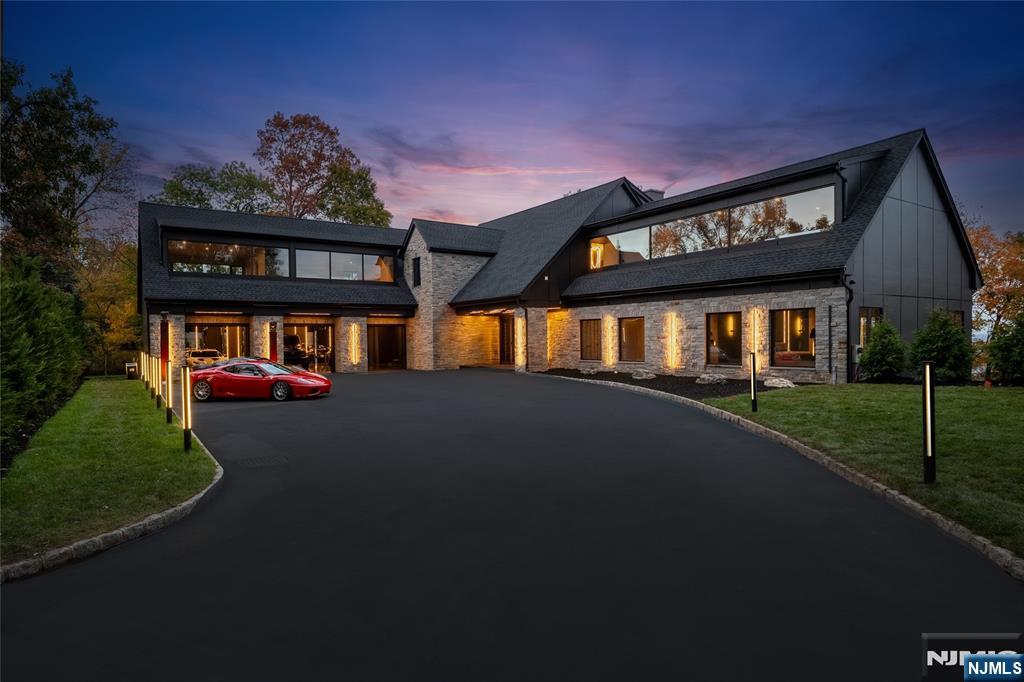Modern. Seductive. Unapologetically bold. Welcome to The Allure â€” a striking architectural masterpiece by ECS Homes redefining modern luxury in Totowaâ€™s exclusive hilltop. This entertainerâ€™s paradise fuses high design and sensual minimalism with soaring spaces, smoked glass railings, black marble staircases, radiant heated flooring, and custom LED lighting throughout. The dramatic great room opens to a massive balcony with panoramic city views, while the designer kitchen with full prep kitchen and main-level primary suite with sculptural tub and smoked-glass shower epitomize indulgence. Upstairs offers a loft with coffee bar and three ensuite bedrooms, including a spa-style alternative primary. The walkout lower level features a gym with infrared sauna and cold plunge, wet bar, and recreation area opening to the resort-style pool and terraces. Finished with radiant floors, epoxy garage for six, generator, and elite imported finishes â€” The Allure defines modern desire.