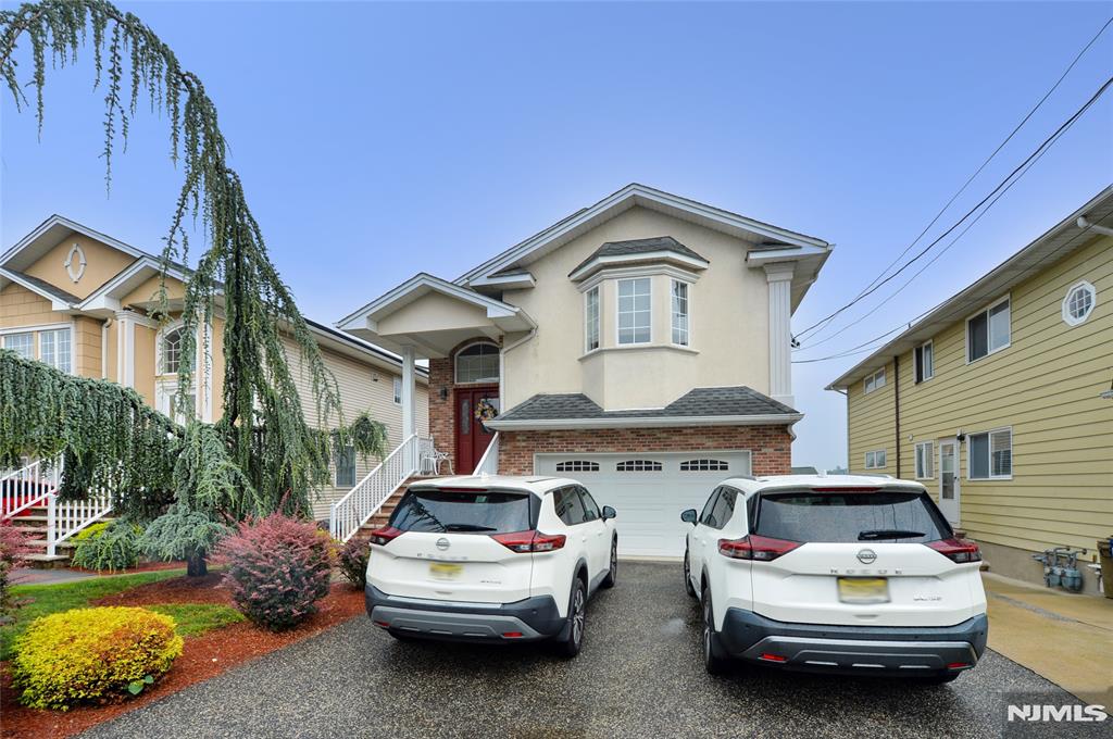 Custom-built in 2005, this exceptional home offers a rare blend of space, comfort, and versatility. Thoughtfully designed for today's lifestyle, it provides an ideal layout for multi-generational living or those seeking flexible living arrangements. The sun-filled main level features a spacious eat-in kitchen with a soaring vaulted ceiling that opens seamlessly to the welcoming family room, complemented by a formal dining room, hardwood floors, a primary suite with a private bath, a second bedroom, full hall bath, and laundry. The ground level offers a beautifully appointed private living area complete with a full kitchen, family room, bedroom, full bath, laundry, and sliders leading to a deckâ€”creating the perfect retreat for guests or extended living. The finished lower level continues the home's remarkable flexibility with a kitchenette, family room, bedroom, full bath, and a third laundry area. A two-car attached garage completes this truly unique home, where thoughtful design and exceptional living space come together in perfect harmony.