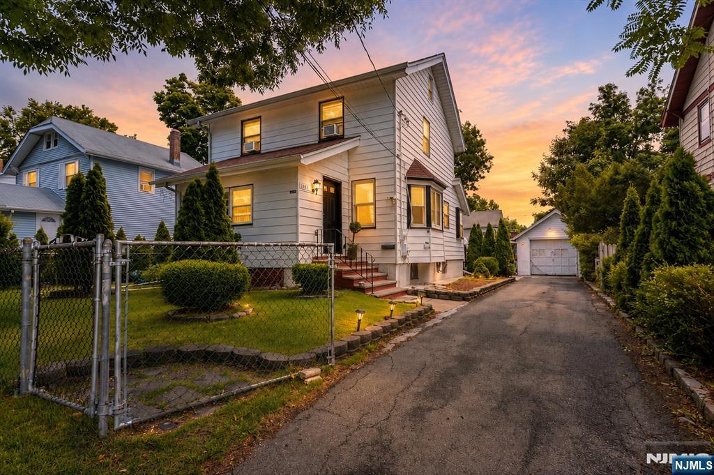 Welcome to this well-maintained 4-bedroom, 3 full bath Colonial offering a spacious and versatile layout in one of Teaneck's desirable residential neighborhoods. The inviting first floor features bright living and dining areas, an updated kitchen with stainless steel appliances, modern cabinetry, ample counter space, and a full bath. Upstairs offers four comfortable bedrooms with hardwood flooring and an additional full bath. The finished lower level provides exceptional flexibility with a large recreation area, second kitchen, full bath, laundry, and additional storage, making it ideal for extended living, guests, or a home office. Enjoy outdoor living in the beautifully landscaped, fully fenced backyard featuring a patio, covered entertaining area, detached garage, and an extended driveway providing ample off-street parking. Conveniently located near parks, schools, shopping, restaurants, houses of worship, and major highways, with easy access to NYC transportation. A wonderful opportunity to own a move-in ready home offering space, functionality, and convenience. Some photos may include virtual decluttering or digital enhancements to better showcase the home's potential while accurately representing the property's layout and features.