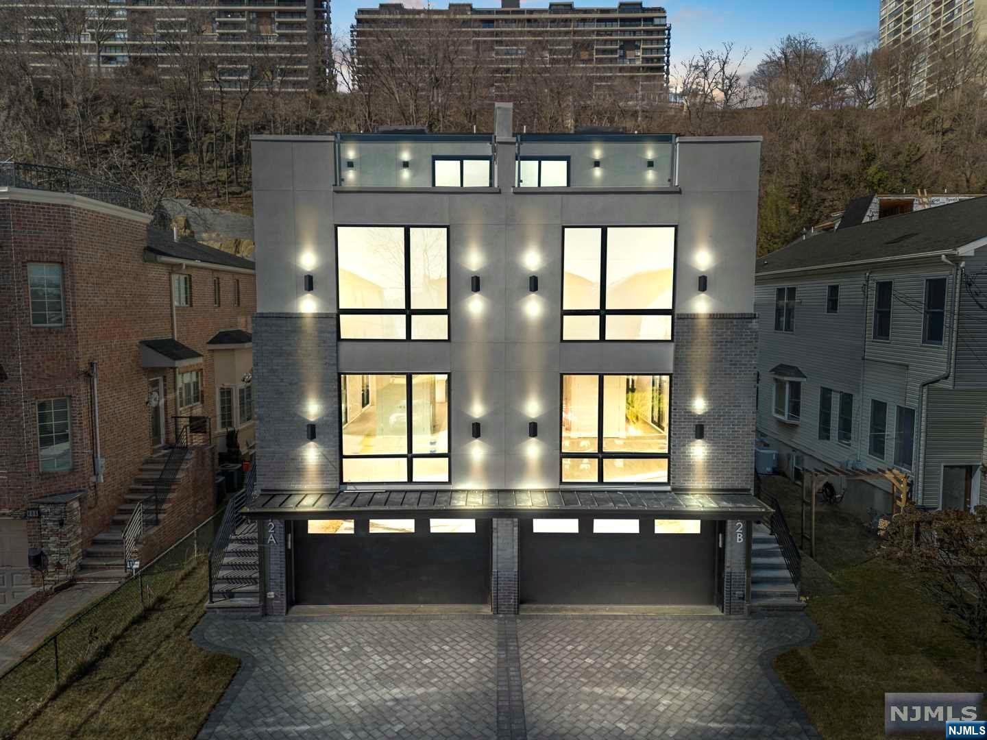 Tucked away high up in North Edgewater sits Myrtle Ave, Edgewater's best-kept secret.This cul-de-sac street is wide, flat and offers a scenic view of the Hudson River and Manhattan.This 4-level modern dream home is offering is built by a top builder.This is a 2Fam side-by-side duplex.Each unit features 3beds, 3full baths, 2half baths with a 2-car garage with a grand terrace.The 1st level offers a 2-car garage, powder room, expansive recreation room and an ELEVATOR that services all 4 floors.The 2nd level is met with an entry foyer, powder room, living room, dining room and a custom stylish kitchen with luxury Sub-Zero and Wolf appliances.The 3rd level offers a posh master bedroom suite complete with 3 closets and a luxurious master bath with double vanity, shower and free-standing tub.Also, the 2nd and 3rd bedroom with a full bath as well as a laundry room.The 4th floor boasts a spacious recreation area with wet bar, powder room and door leading out to the private rooftop terrace