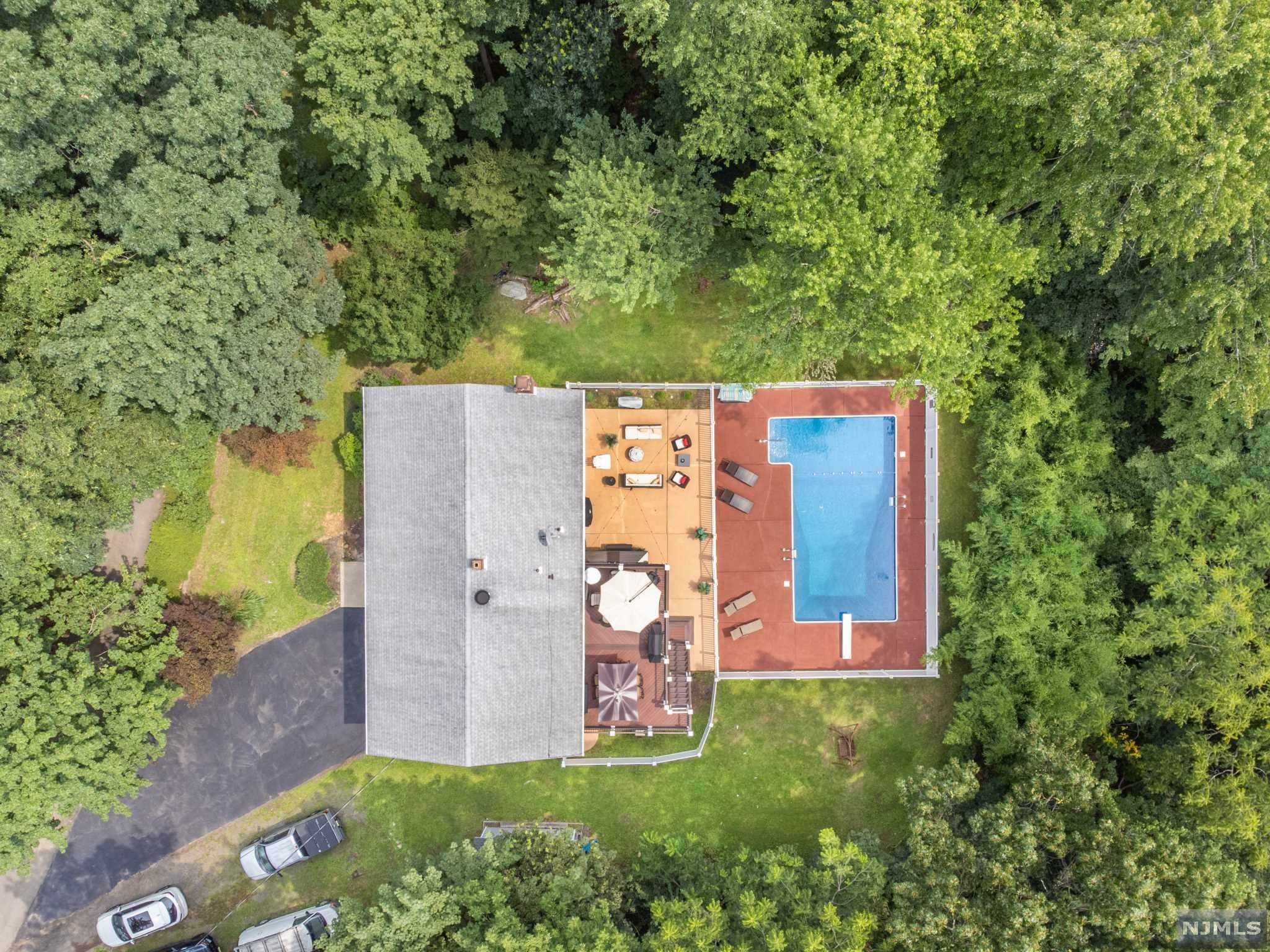 Welcome to this secluded, totally updated Oasis, tucked away but yet in walking distance to Restaurant and shopping, also very convenient to highway, major Trans and just 30 miles from NY City. This entertainer's delight is situated on 1/2 acre of resort-like property. Main level features 3 Bedrooms (Master-BR with a full bath), Main bathroom, Living Room with electric Fireplace, Brand new Custom-Kitchen with upgraded appliances and Quartz tops opens to FDR and SGD to upper deck. Make your way to the ground Level with an additional 4th bedroom/guest room/in-law suite, family room w/wood fireplace and another full bath! All this opens to a fenced in backyard with patio and an in-ground-pool. 2-Car garage and plenty private parking area completed this must see Custom Home... Septic is a 3 Bedroom Town Verified.