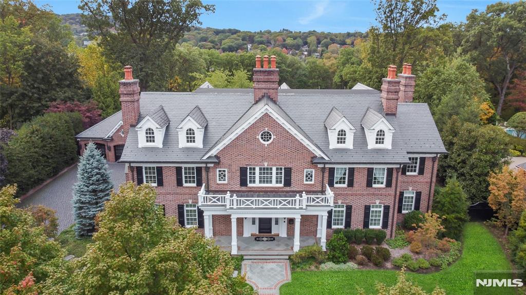 Offered for the first time, this extraordinary custom-built estate spans over 15,000 square feet across four elevator-serviced levels, set on 3.3 acres of private, manicured grounds. A grand foyer with fireplace introduces the home's scale and refined architectural presence. To one side, a banquet-sized dining room connects to a fully appointed butler's pantry with icemaker, dishwasher, and wine cooler. To the other, formal living and music rooms lead into a spacious family room and a glass-enclosed, all-season porch. At the heart of the home, the chefâ€™s kitchen is anchored by dual islands, a La Cornue range, and a sunlit breakfast nook. With 7 bedrooms, 9 full baths, and 5 half baths, the layout is designed for both large-scale entertaining and everyday living. Interior amenities include a billiard room, game room, private theater with tiered seating, temperature-controlled wine room, gym, art studio, mudroom with custom cubbies, multiple home offices, several laundry areas, and generous storage throughout. The resort-style grounds feature a heated gunite pool with full-service cabana, illuminated tennis court, and mature landscaping offering total privacy. A detached three-car garage includes butler quarters and an oversized storage room. A rare opportunity to own a private compound of this scale and quality - minutes from shopping and surrounded by nature.