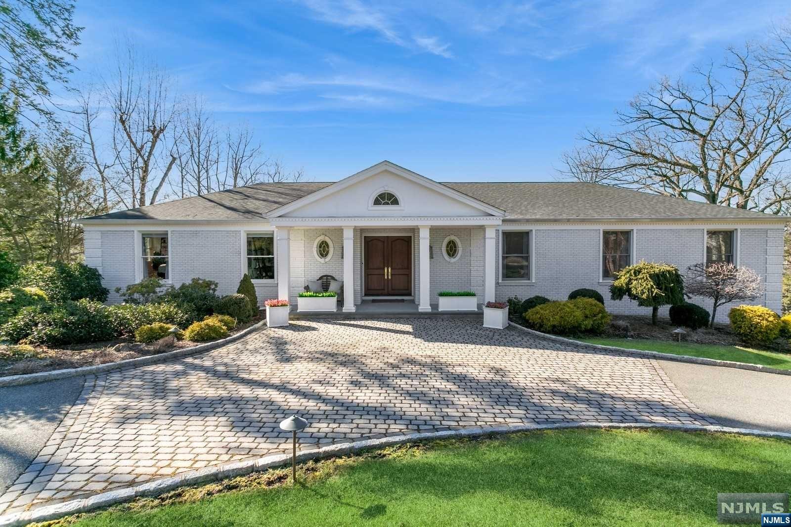 Watch the sunset, gaze at the Ramapo mountains and enjoy four seasons from the full level wrap around deck of this one of a kind home. A few yards from the Nature Center and located on a cul-de-sac, this one of a kind ranch with high ceilings and exquisite moldings has 6 large bedrooms and 3 1/2 renovated baths. The home encompasses over 5500 square feet of living space which includes a spacious finished lower walk out level with additional 2 bedrooms/office, 2 full bathroom, a wet bar, sitting area, lots of storage and 3 car garage. The property is a 1 acre with lush areas to entertain plus a lighted sports court to play tennis, badminton, basketball and more any time of day or night. The ease of modern upscale living, with a landscaped acre, incredible views, and the amazing location make this home a must see.