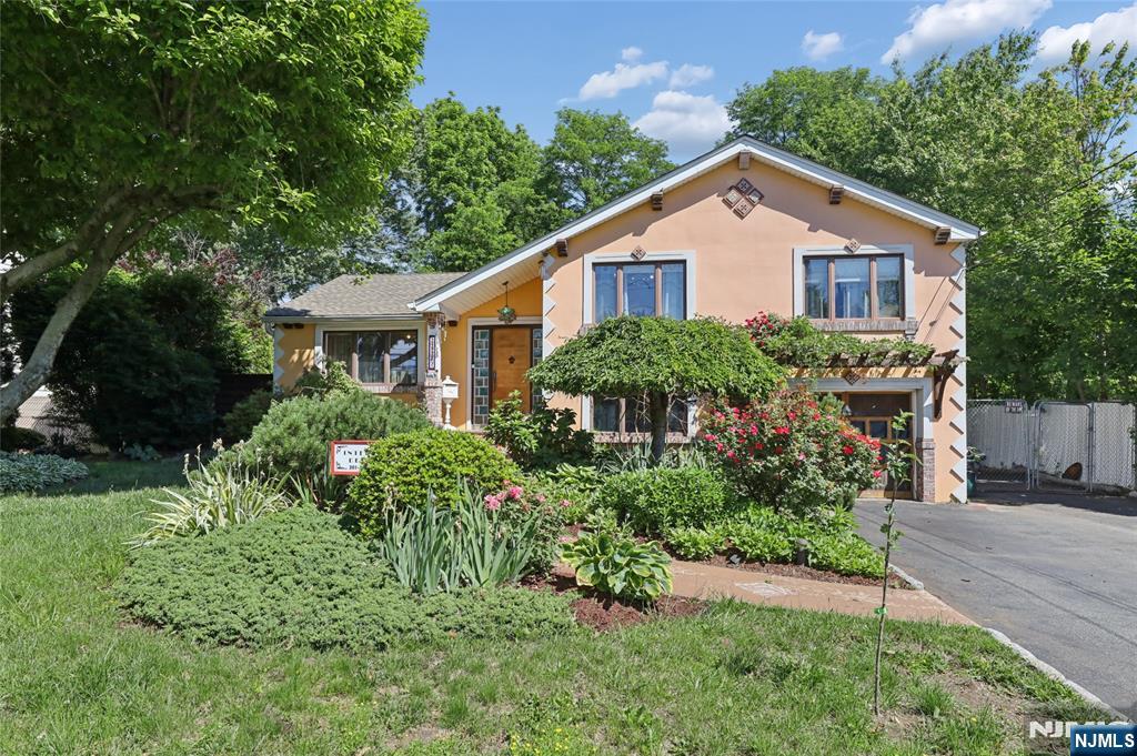 Welcome to one of the most unique homes in Fair Lawn. This award-winning custom Mediterranean-inspired residence offers exceptional space, character, design, and versatility. The main living area features a bright and open layout highlighted by soaring ceilings, skylights, and abundant natural light throughout. The updated kitchen flows seamlessly into the living and dining spaces and provides direct access to a large deck overlooking a picturesque park-like backyard complete with a wood-burning pizza oven, creating the perfect setting for entertaining or relaxing outdoors. A private side entrance leads to an expansive bonus living area, ideal for entertaining and large gatherings, with direct access to the backyard. This versatile space also connects seamlessly to an additional bedroom or home office, offering flexibility for guests, remote work, or multi-generational living. The upper levels feature spacious bedrooms, including an incredible primary suite complete with a huge walk-in closet, spa-like bath, and beautiful private balcony. The finished basement offers additional living space, a full bath, and laundry area. Set on beautifully landscaped grounds with ample parking, this impeccably maintained home is conveniently located near NYC transportation, shopping, dining, houses of worship, major highways, parks, and schools. A truly special property offering space, flexibility, and a lifestyle rarely found in today's market.