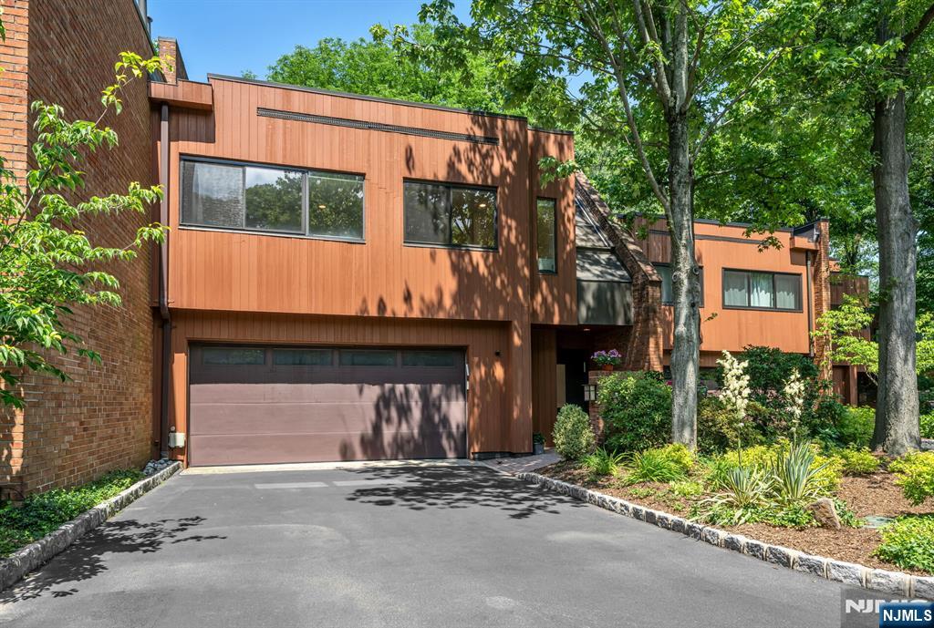Welcome to 12 Kira Ln, a beautifully updated townhouse in the sought-after Summit Woods community on Englewoodâ€™s East Hill. Filled with natural light, the open-concept main level features spacious living and dining areas, a redesigned kitchen with a large center island, custom cabinetry, Thermador appliances and marble flooring. The primary suite occupies its own private level and offers walls of windows, skylights, a walk-in closet, and an updated ensuite bath. Two additional bedrooms, a full bathroom, and a laundry room are located on the level below. The lower level features a family room with a fireplace, a powder room, and access to the private patio and backyard. Additional highlights include an attached two-car garage and a location convenient to parks, shopping, dining, and transportation to New York City.